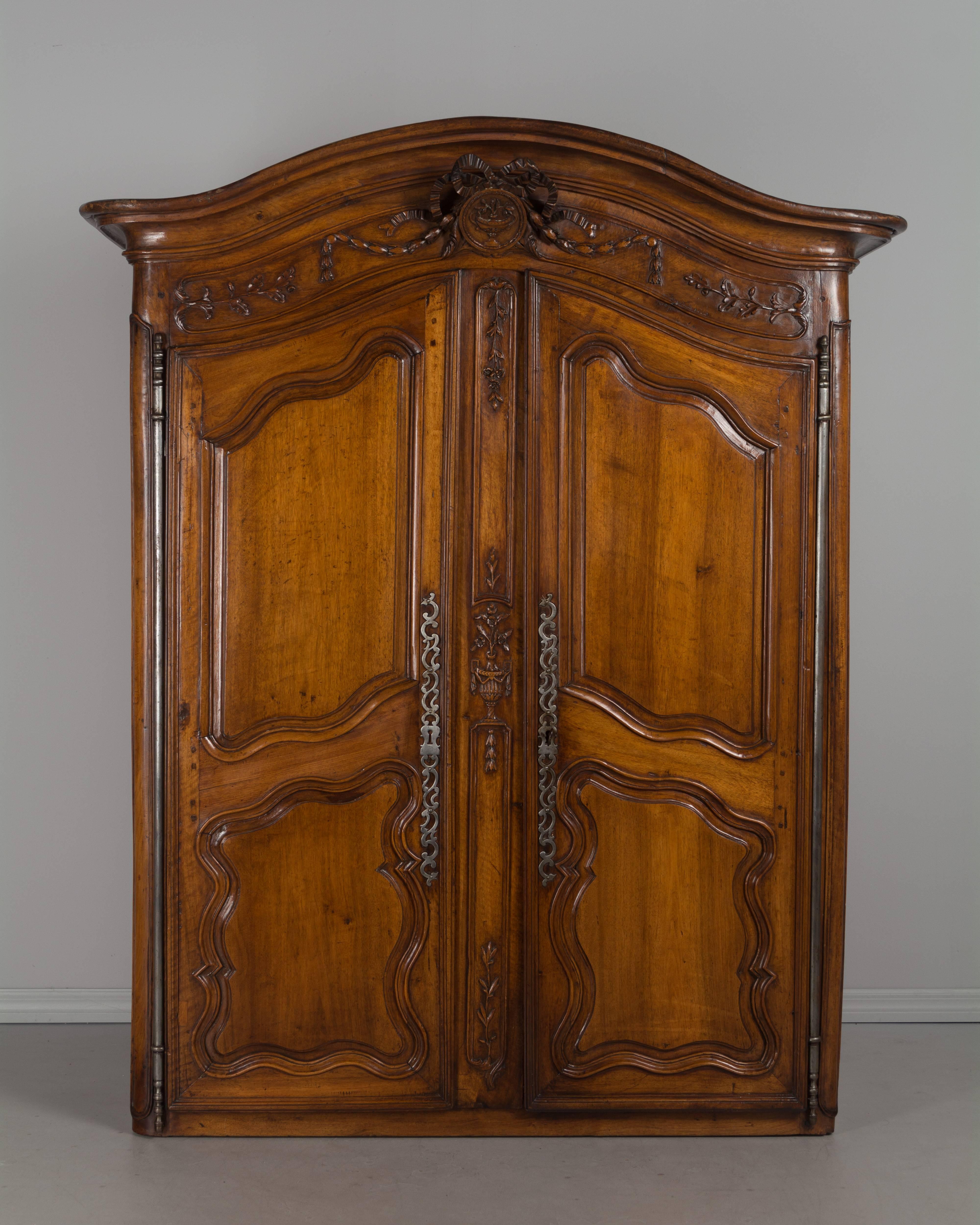 A large 18th century French Louis XV buffet à deux corps made from thick planks of solid walnut. Excellent craftsmanship and grand in scale at 10 feet tall, the provenance of this buffet is a chateau in St. Remy de Provence. The top has a chapeau de