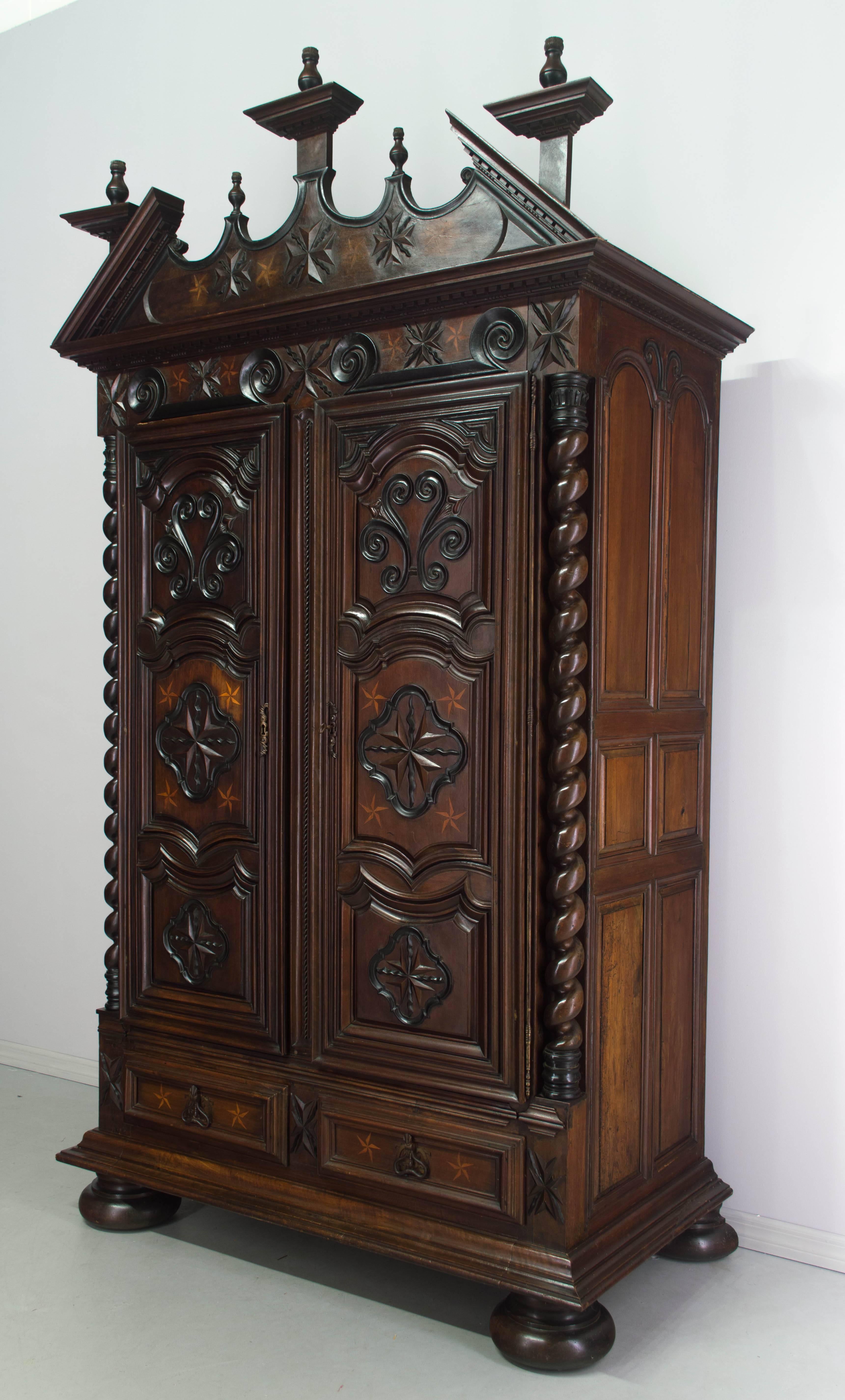 An exceptional Louis XIII style armoire from a chateau in the Southwest of France near the town of Agen. Made of exotic woods including ebony, rosewood, lemon and walnut. Magnificent hand-turned twisted columns. Raised panel doors with inlaid