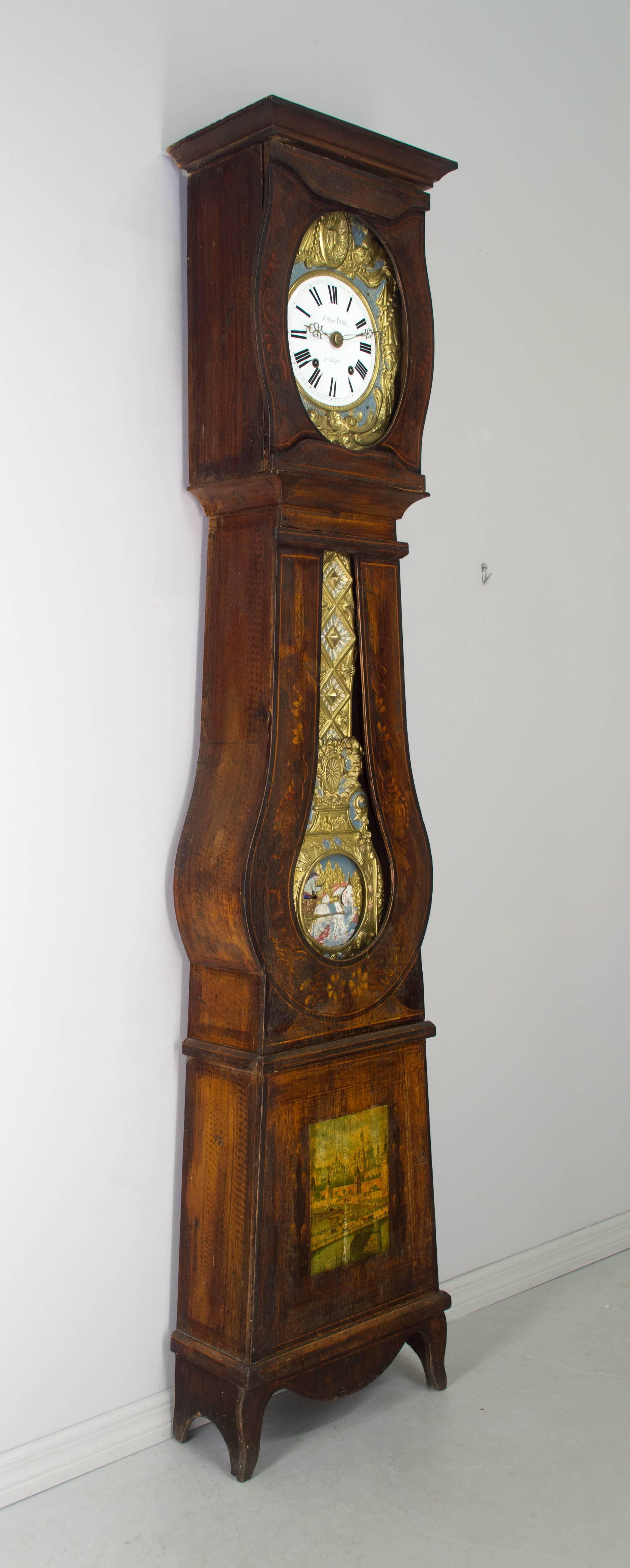 A good comtoise or grandfather clock watch polychrome painted pine case and automated pendulum. Original seven day Morbier movement, cleaned and in working order, having an enamel face, signed by the clockmaker, Hubert Fevrier and the name of his