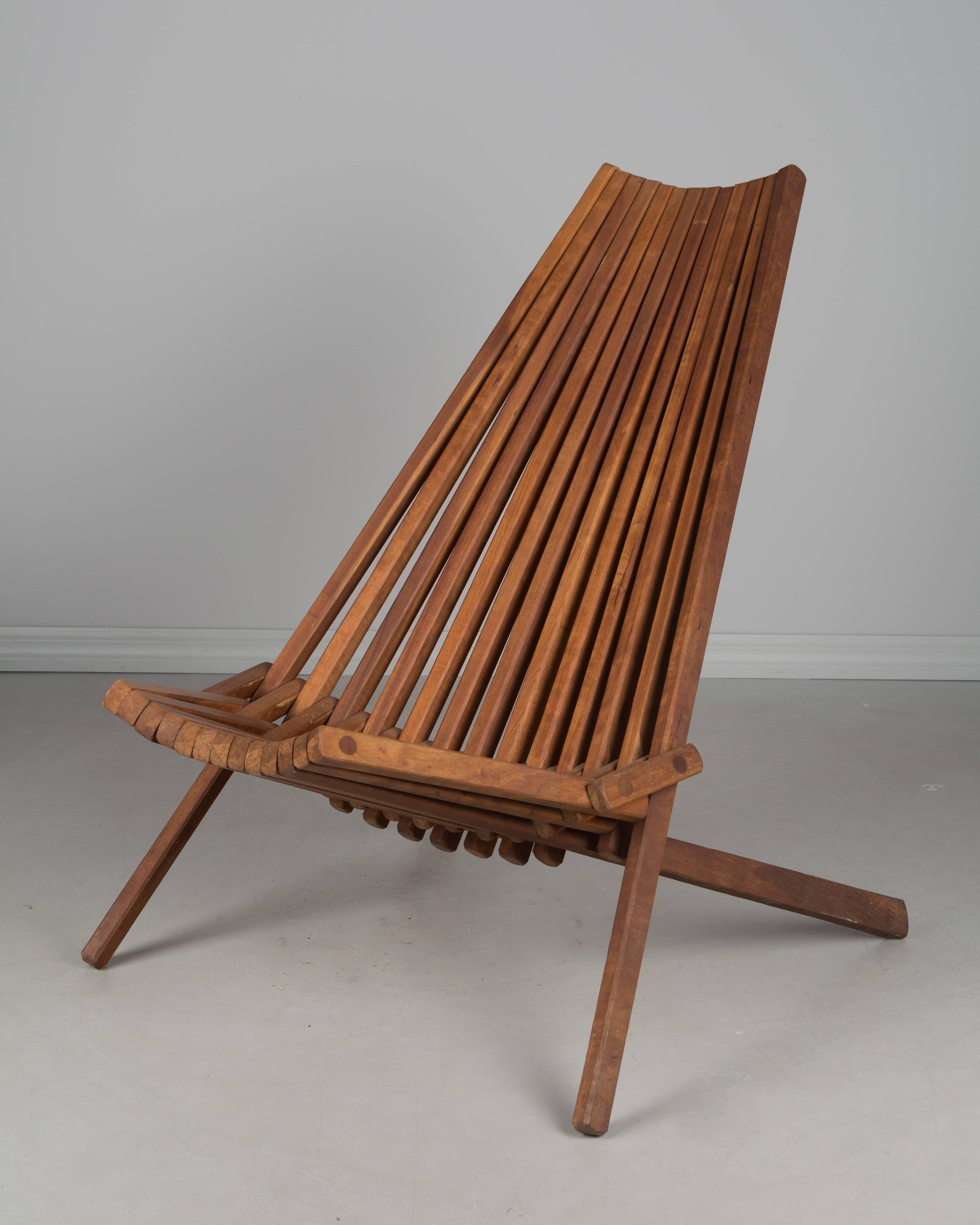 Mid-Century wood slat folding lounge chair. Made of teak with superb construction using no screws. Folds flat for easy storage. Very comfortable, this chair can be used indoors or out.
More photos available upon request. We have a large selection of