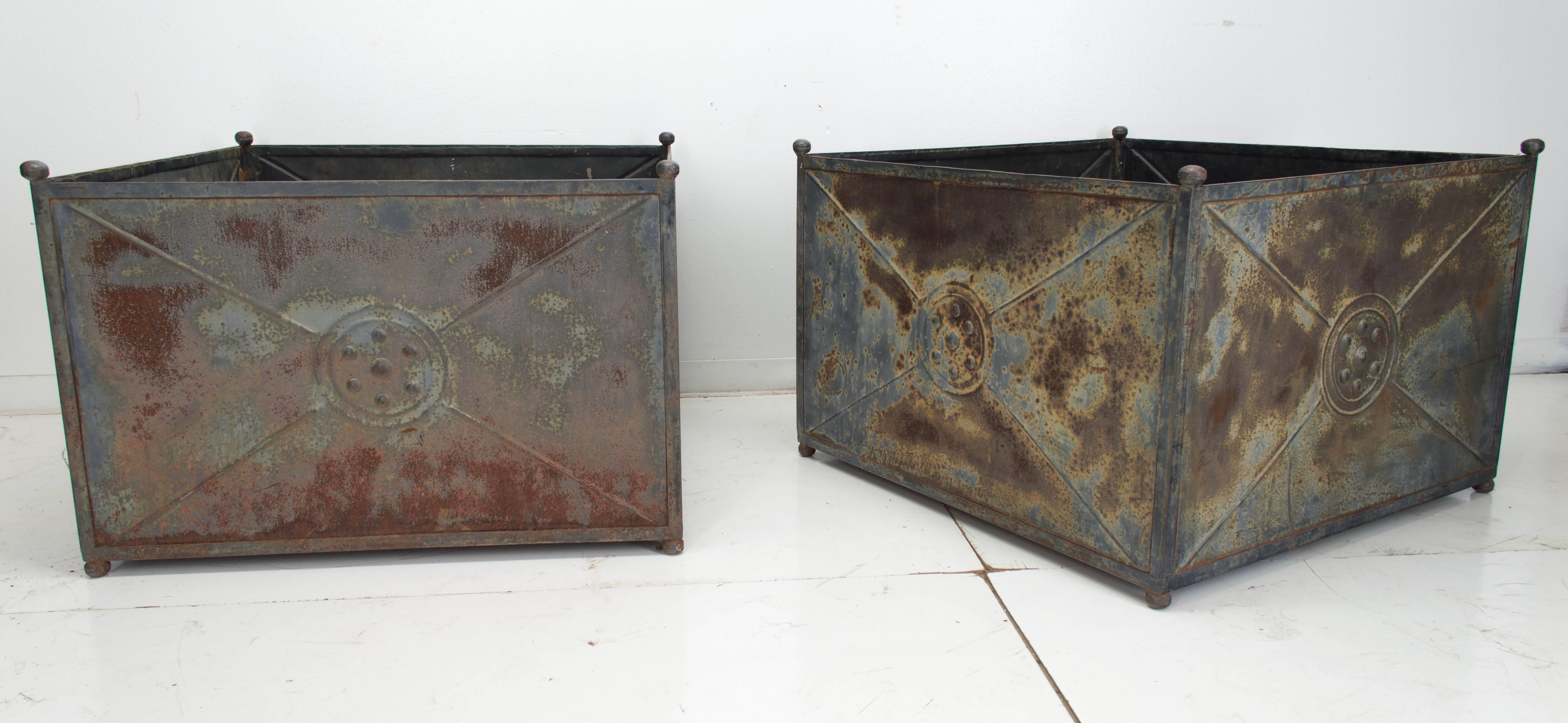 A pair of large zinc garden planters for use as part of your garden landscape or in a greenhouse for citrus trees. Unusual large size and nice weathered patina. In great condition considering the age. We have a large selection of French antiques.