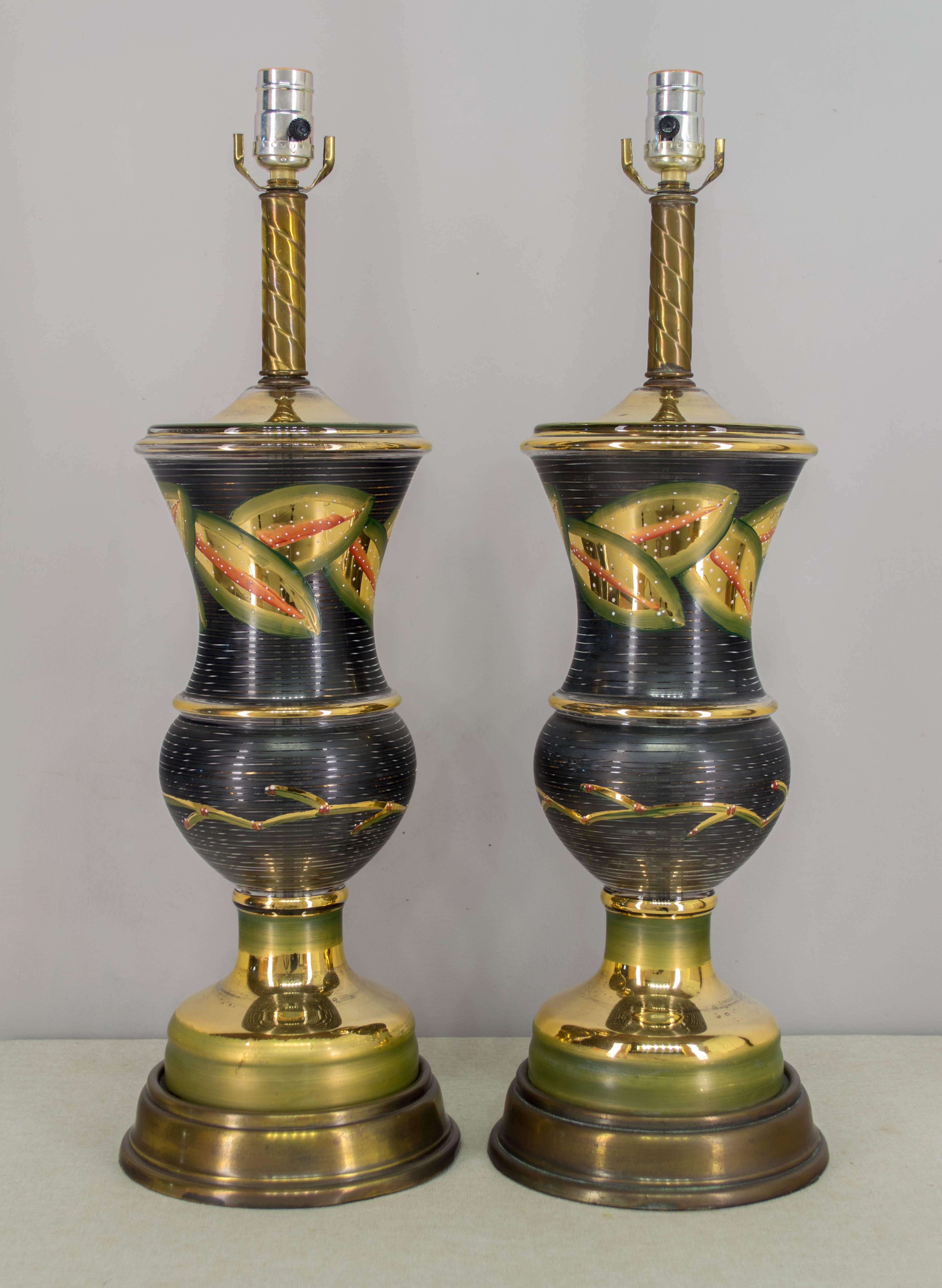 Pair of Venetian glass lamps with urn shape and painted decoration. Brass base and neck. Rewired and in working order.
Silk shade is not included, but measures 12" H x 12"Dia. top x 14"Dia. bottom.
Height to top of socket is