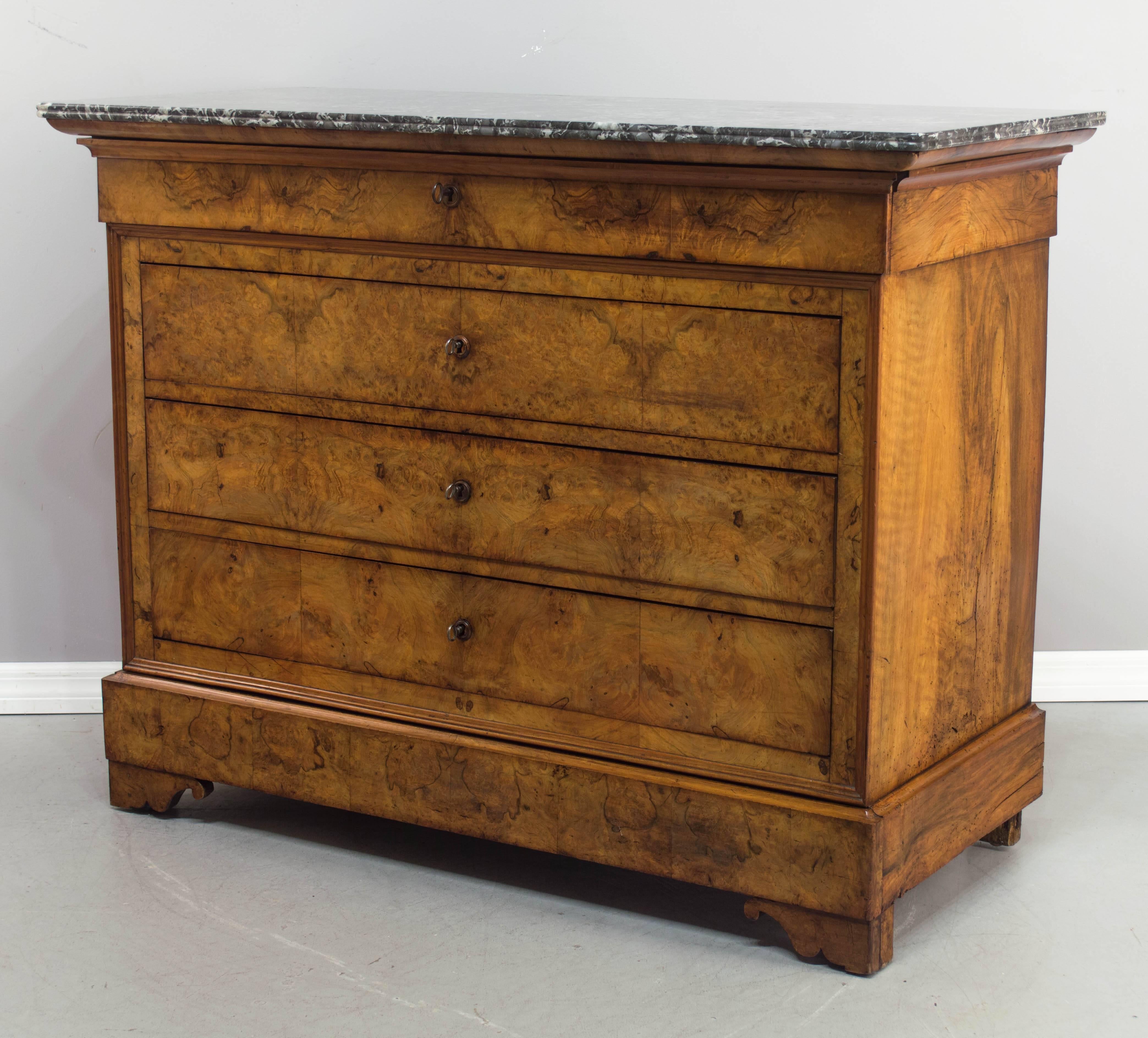 19th c. Louis Philippe commode, c.1820-1840 with five dovetailed drawers and original St. Anne grey marble top. Made of burl of walnut (front) and solid walnut (sides), with oak as a secondary wood. Drawers open easily and locks are in working