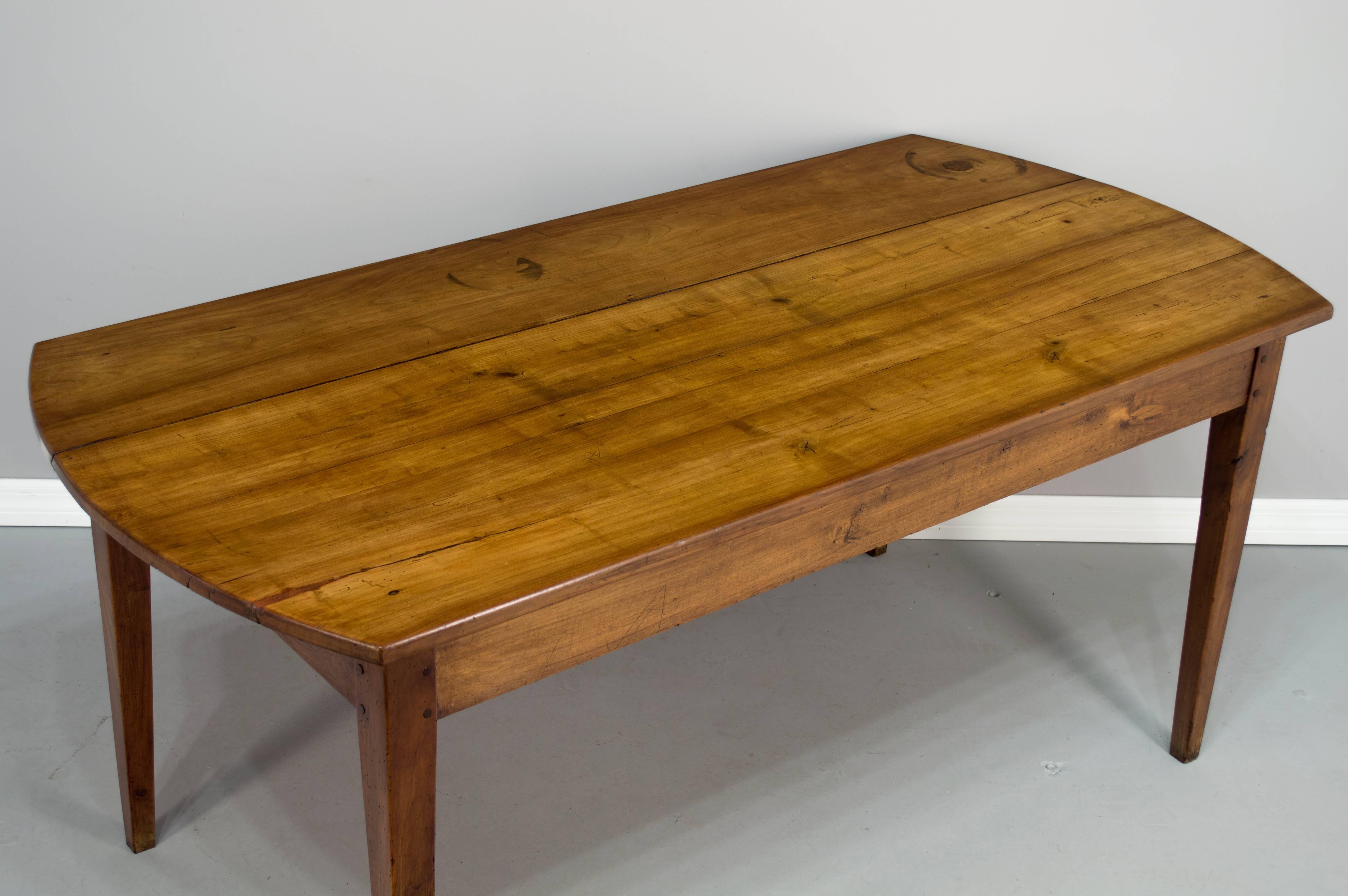 French country farm table from Normandy, c.1900-1920. Made of cherry with tapered legs and pegged construction. 64.5