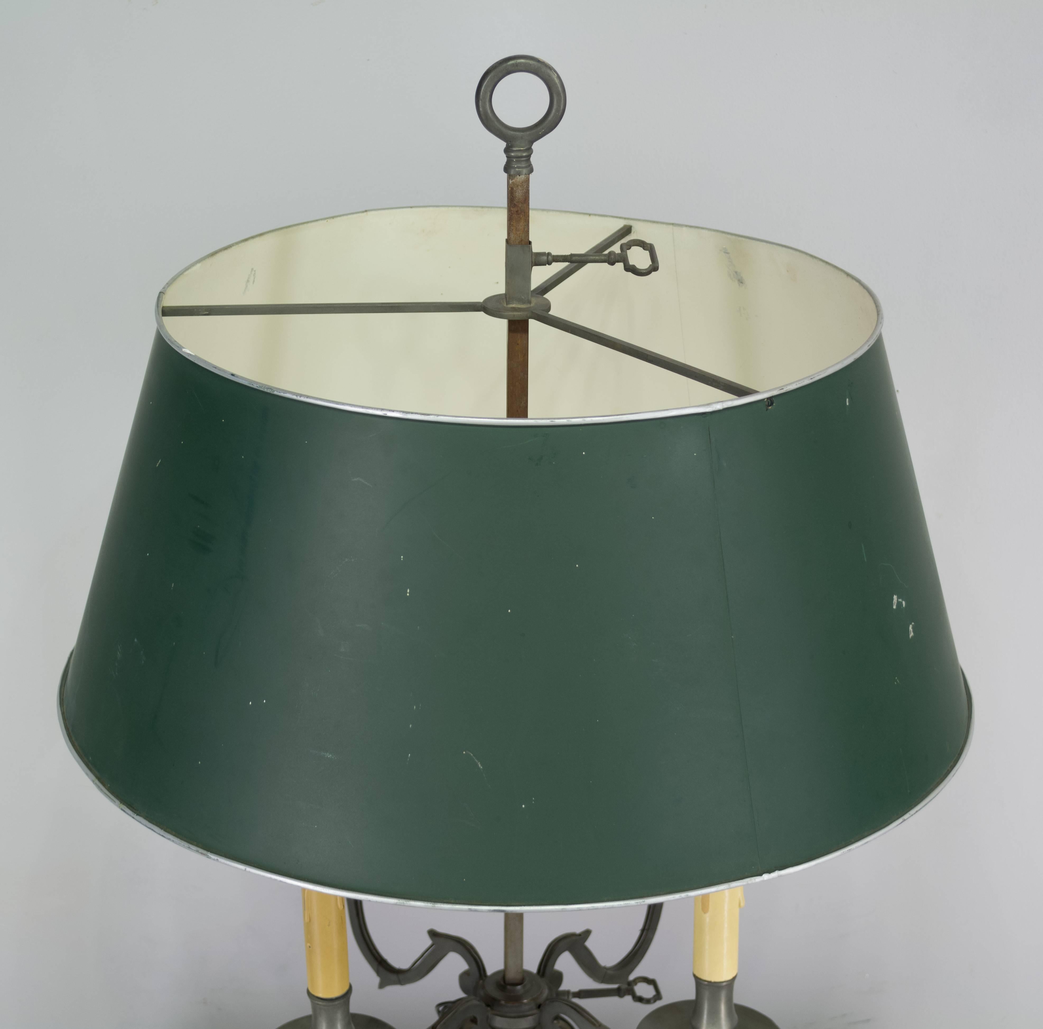 French bouillotte table lamp, circa 1900 made of pewter with green painted tole shade. Large in scale and adjustable from the top and bottom: the shade and the four-arm candelabra may be raised or lowered. Wired and in working order with European