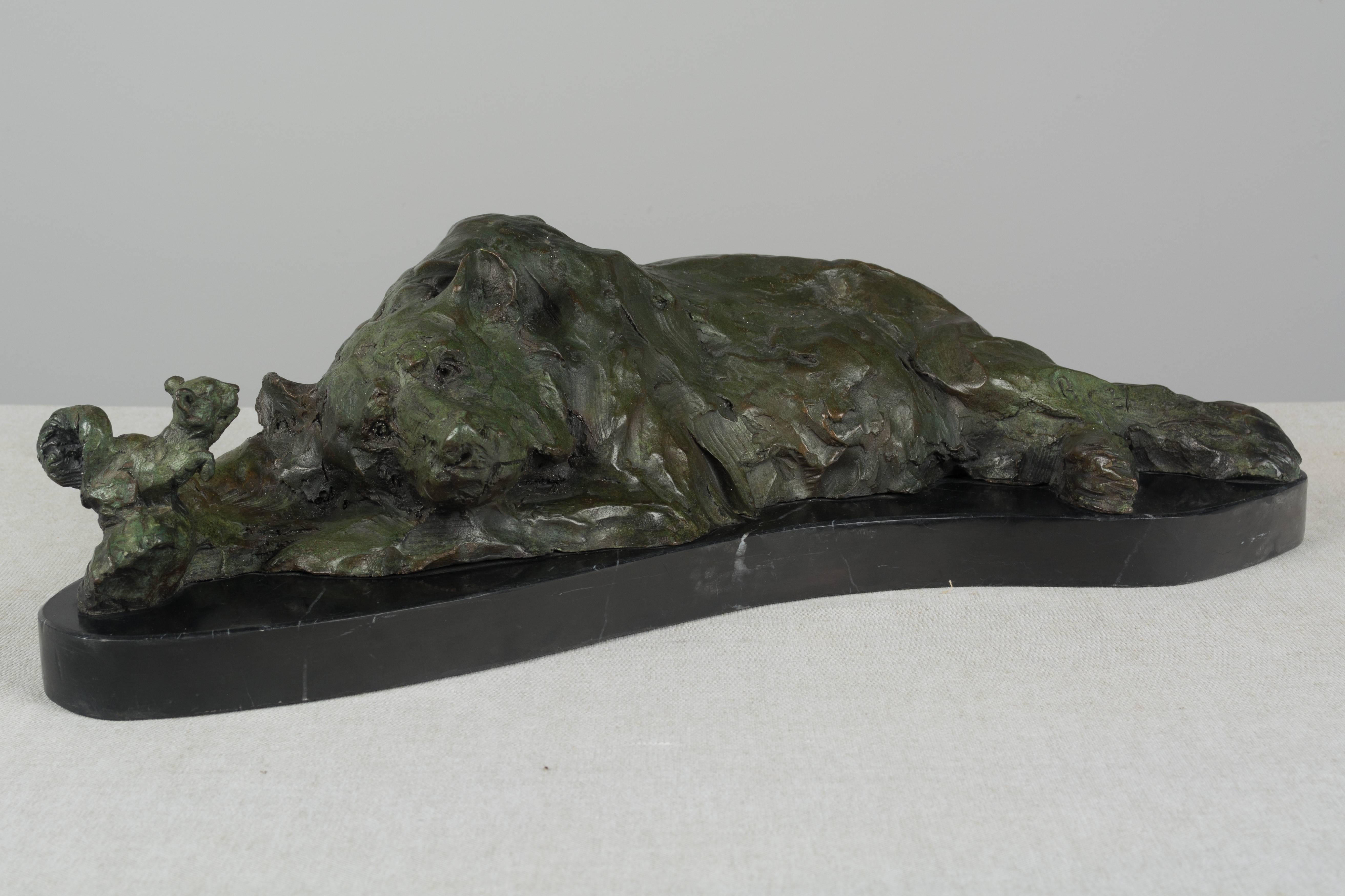 A charming 19th century bronze sculpture of a resting bear and a squirrel. The little squirrel sits on the bear's paw and appears to be whispering in his ear. Perhaps a scene from a children's fable. Beautiful green patina. Black marble base.