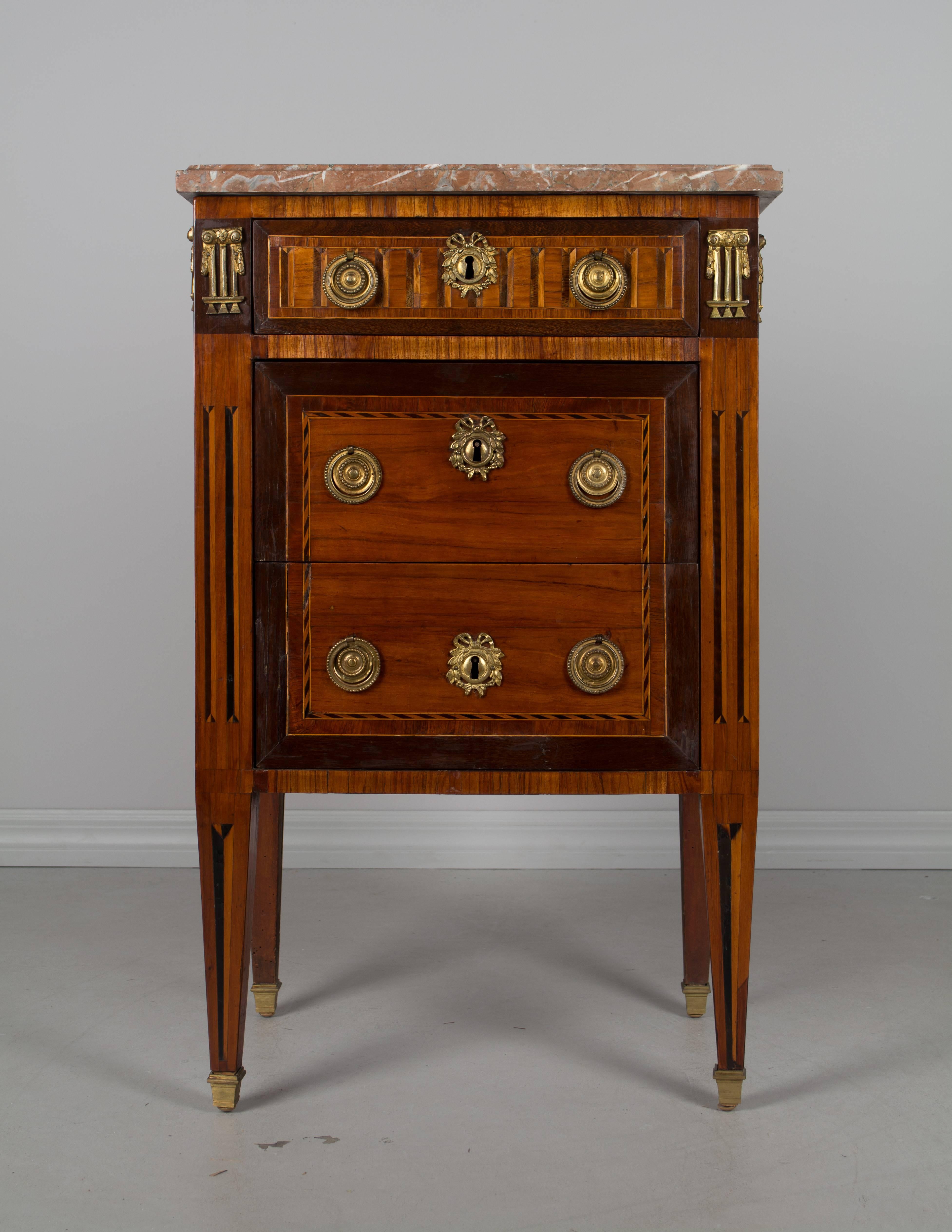 A fine 18th century Louis XVI petite marquetry commode by Parisian ebeniste (cabinet maker), Martin Ohneberg (b. Germany 1738). Beautiful inlay of mahogany, walnut and tulip wood with French polish finish. Oak as a secondary wood. Three dovetailed