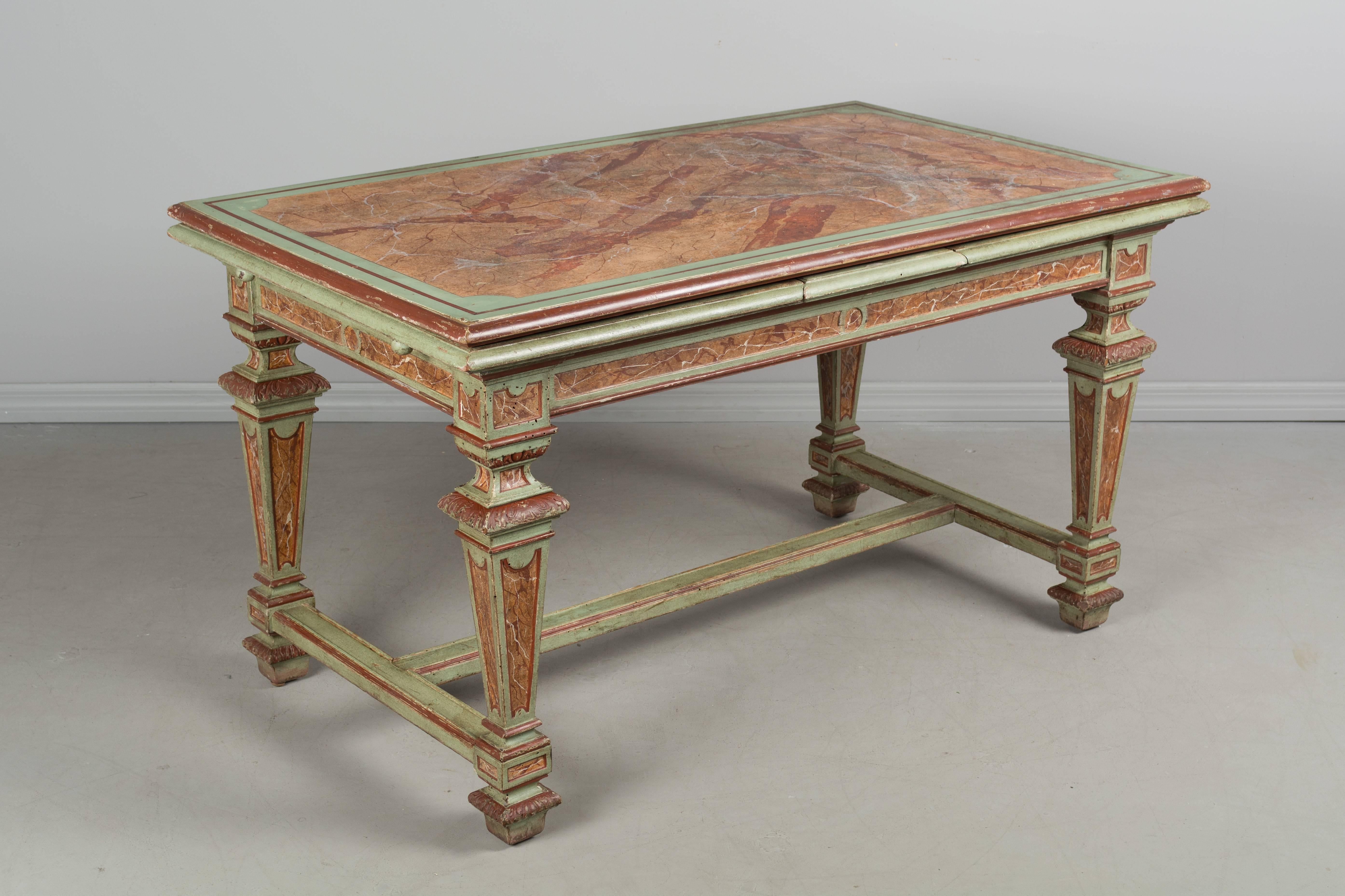 French  Louis XIV style extension table, circa 1900 with faux marble painted finish that was done in the 1950s. Elaborately decorated legs with stretcher. Two extensions with verdigrises painted finish pull-out on the sides. Beautiful old painted