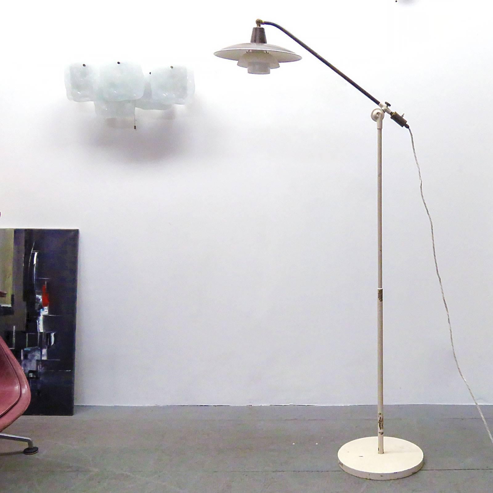 Stunning 1940s floor lamp, model 'Vandpumpen' (water pump) by Poul Henningsen for Louis Poulsen, with adjustable arm. (H.130-150 cm) upper shade and socket cover in brass, middle and lower shade in opaline glass, bottom diffuser in frosted glass.