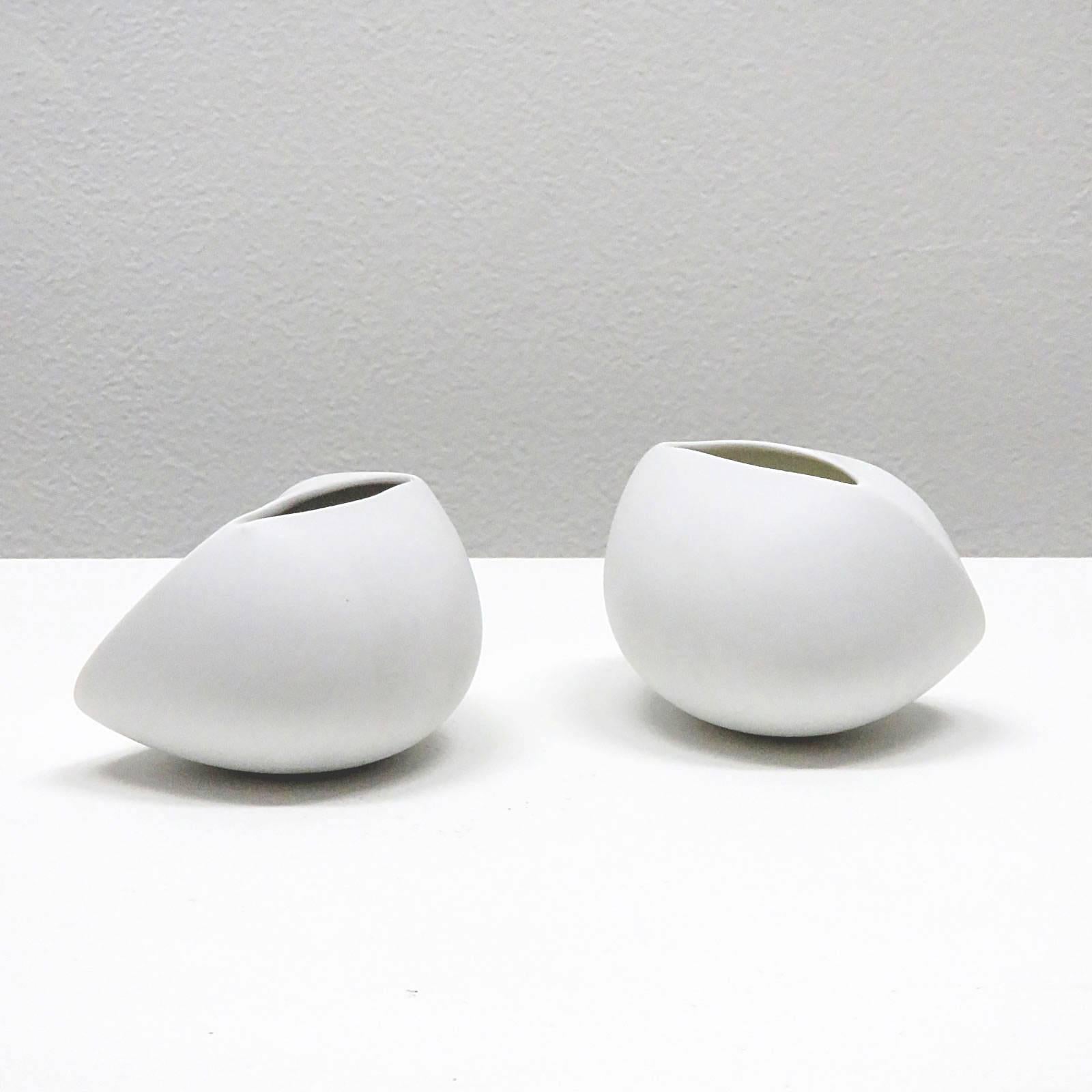 Pure white matte porcelain, organically shaped vases by Uta Feyl for Rosenthal, signed, priced as a pair.