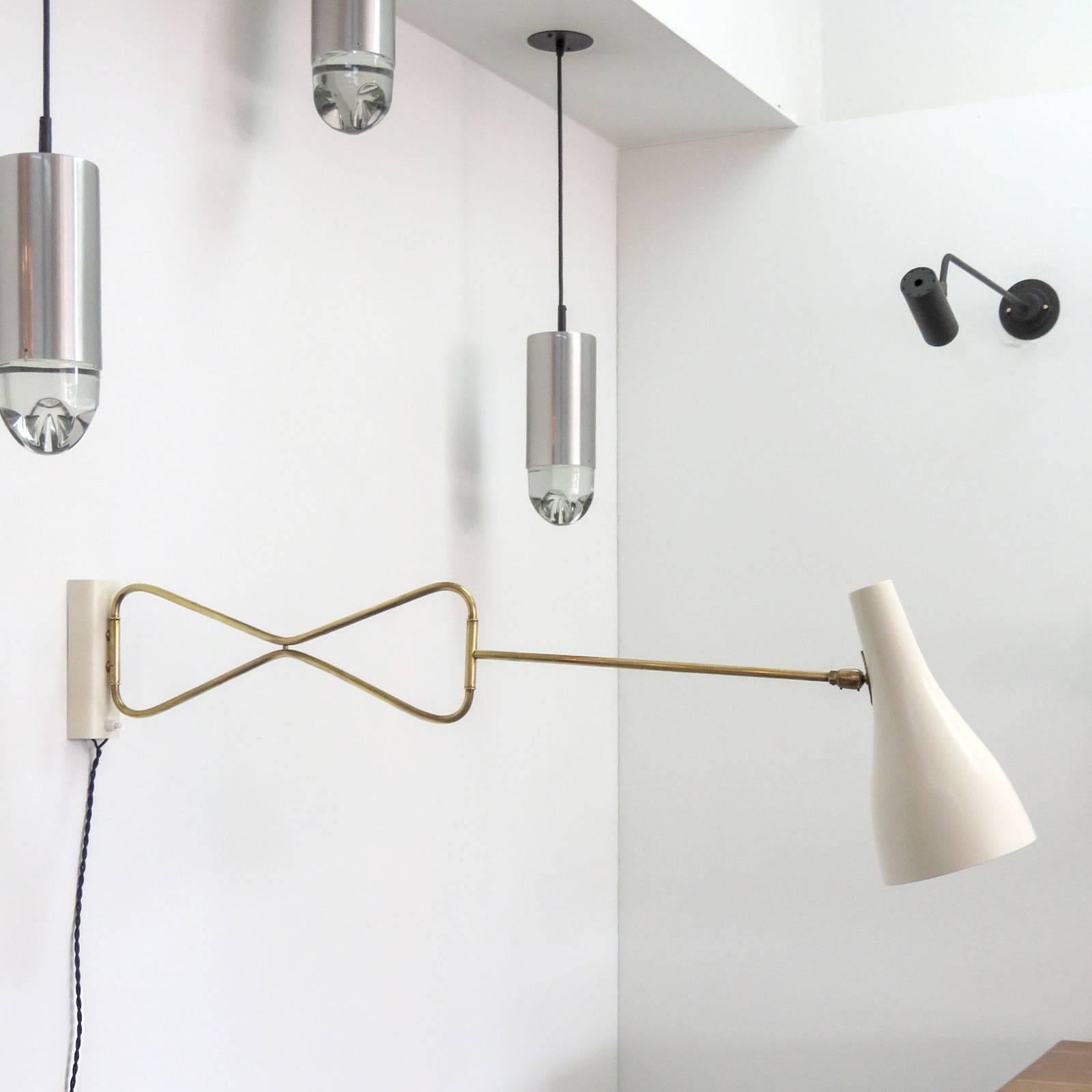 Elegant Austrian double-fold swing arm sconce in brass and enameled metal, egg shell white, currently corded, can be hardwired.