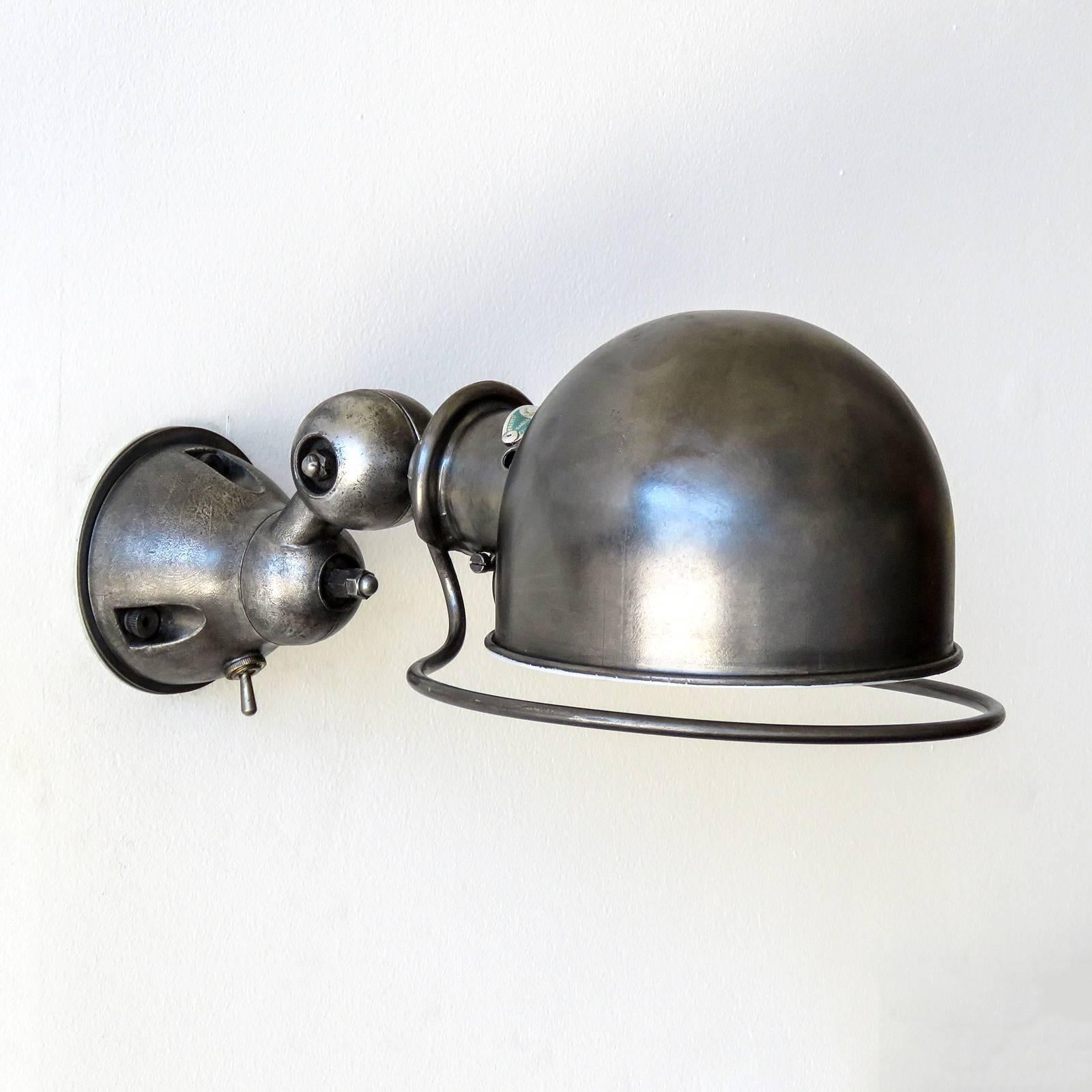 Industrial wall lights by Jean-Louis Domecq for Jielde, each sconce rotates and swivels separately on two axis for full coverage. Green plate edition with a graphite finish and white enameled inside of the shade. Priced as a pair @ $2600.00