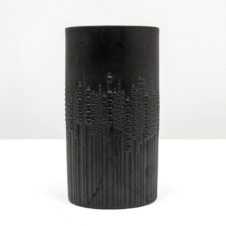Stunning cylindrical black matte porcelain vase designed by Tapio Wirkkala for Rosenthal/Siemens, with sublime relief of beaded pearls running down vertical lines, gives an impression of movement, marked.