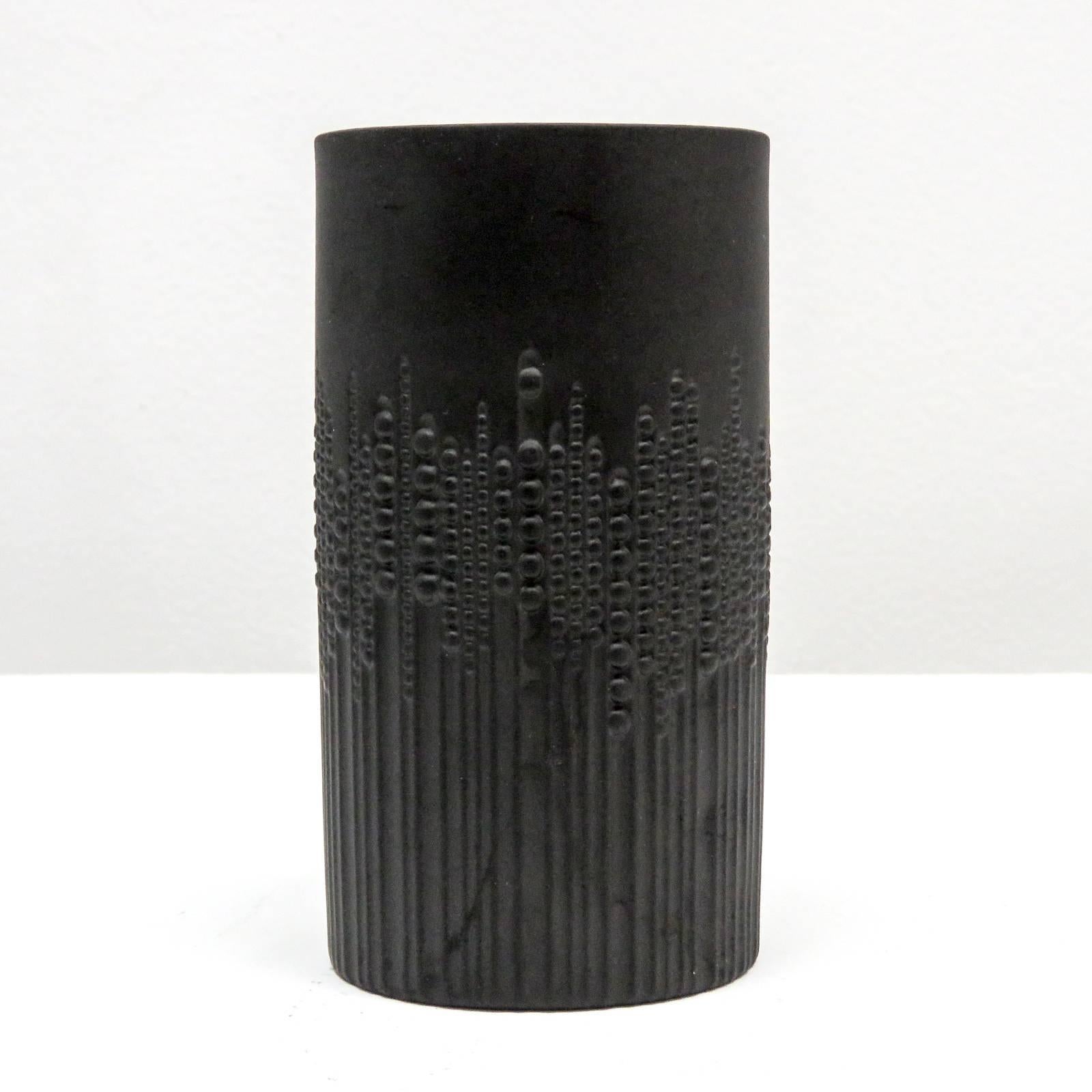 Stunning cylindrical black matte porcelain vase designed by Tapio Wirkkala for Rosenthal/Siemens, with sublime relief of beaded pearls running down vertical lines, gives an impression of movement, marked.