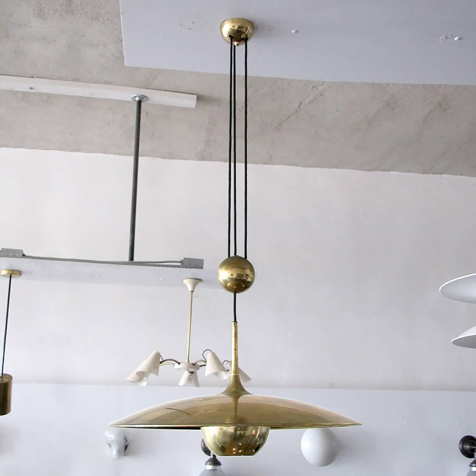 Large brass saucer by Florian Schulz with pulley mechanism, a heavy brass ball counter balances the weight of the fully adjustable shade.