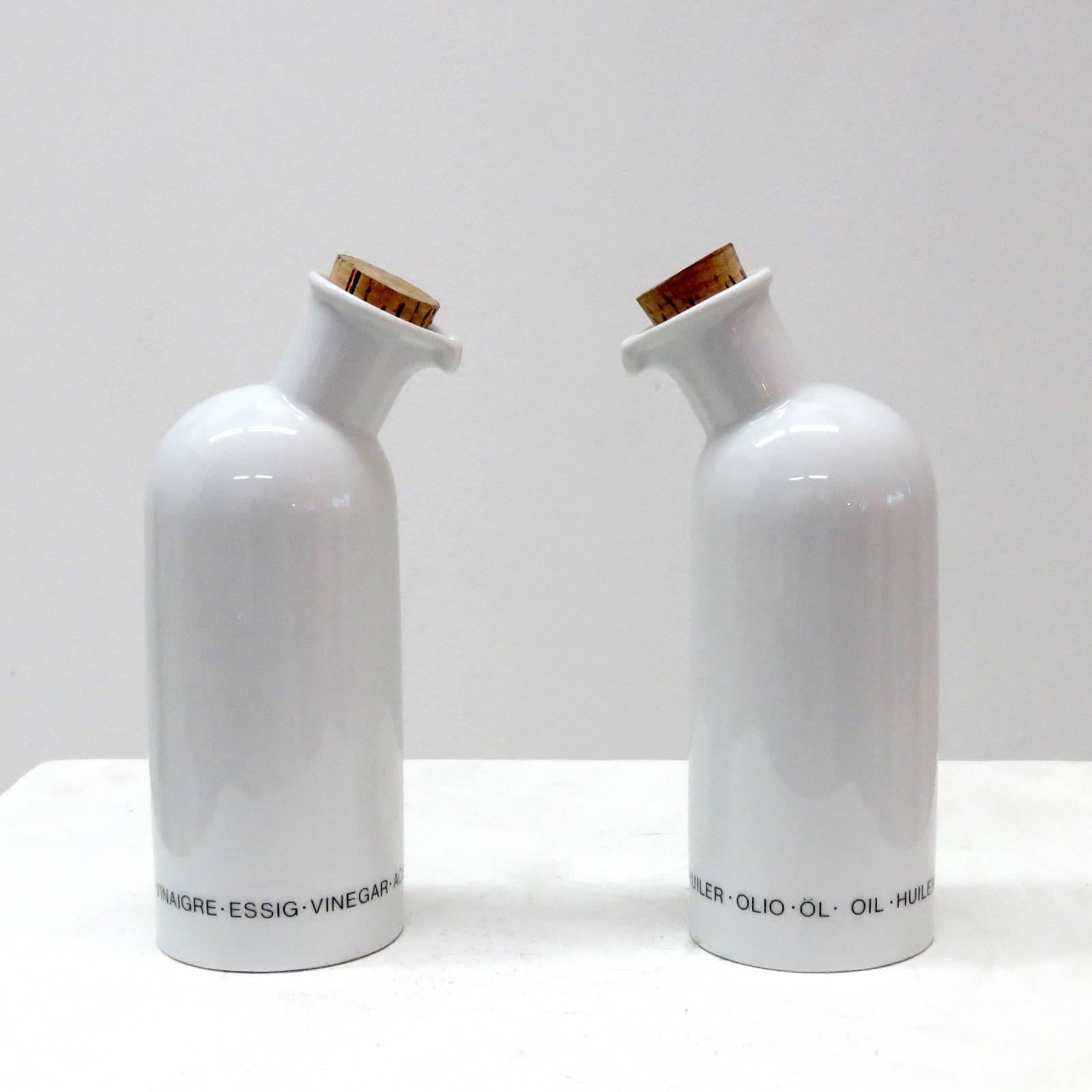Wonderful white porcelain oil and vinegar serving bottles by Arzberg, Germany with cork caps, multilingual signage, marked.