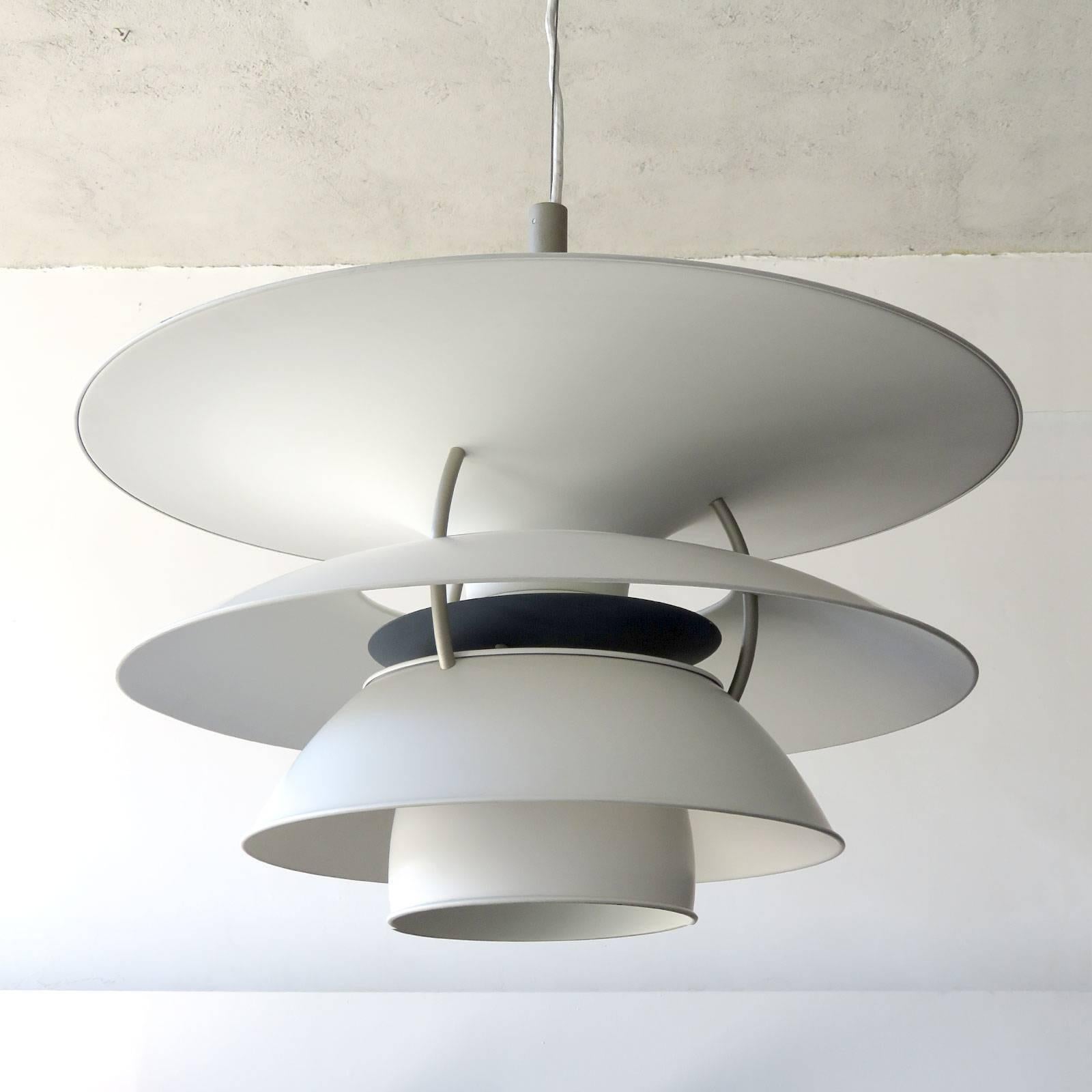 Wonderful large-scale pendant by Poul Henningsen for the Charlottenborg Exhibition Hall in Copenhagen, produced by Louis Poulsen, the enameled metal body is predominately white with grey hardware and dark blue reflector disc, current drop of