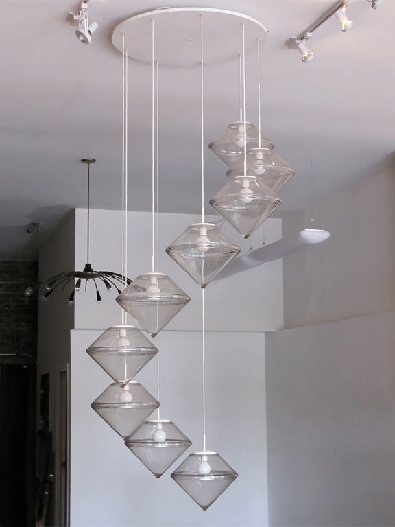 Monumental chandelier by RAAK, comprised of nine clear acrylic cascading forms, large circular canopy in enameled metal.