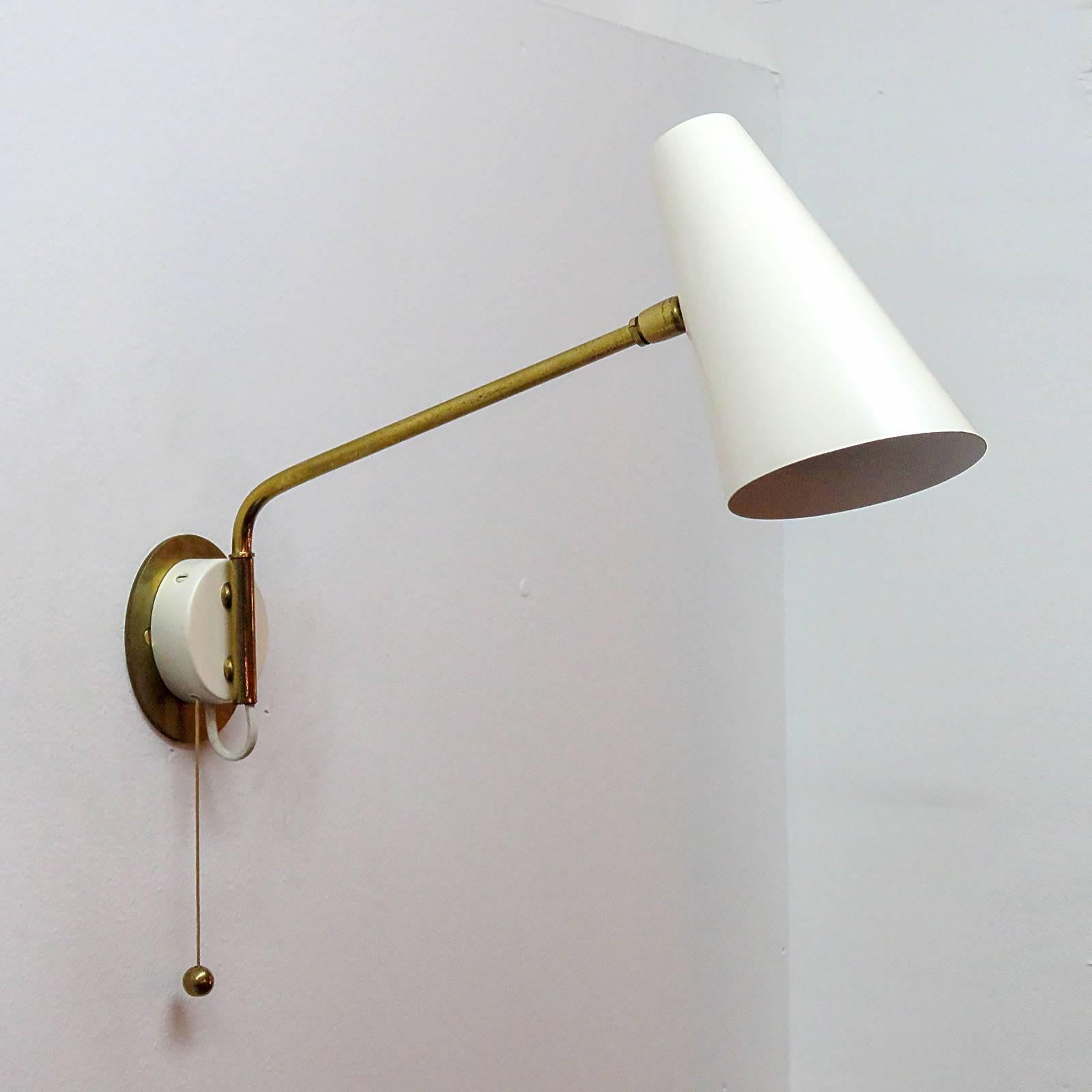 Elegant wall lights with articulate brass swing arms by Stilnovo with adjustable egg-shell color shade and pull switch.