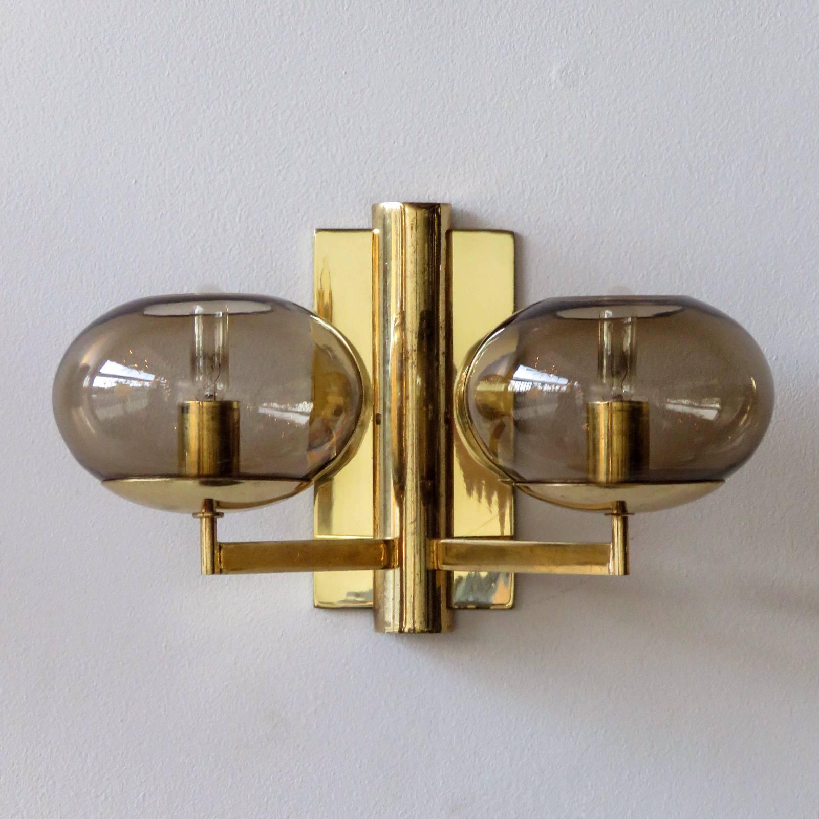 Wonderful pair of double arm wall lights by Gaetano Sciolari in brass with two smoked glass shades each.