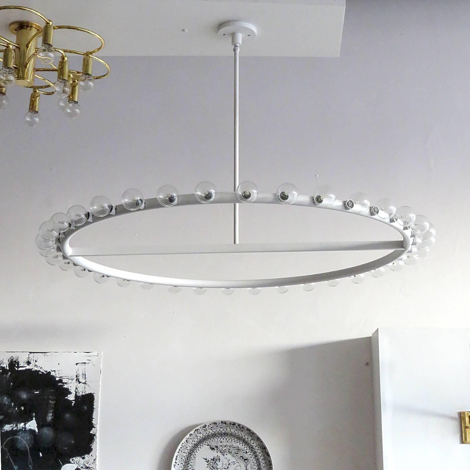 Stunning circular matte white enameled aluminum and brass 36 bulb ring chandelier for Lightolier in style of Alvin Lustig.