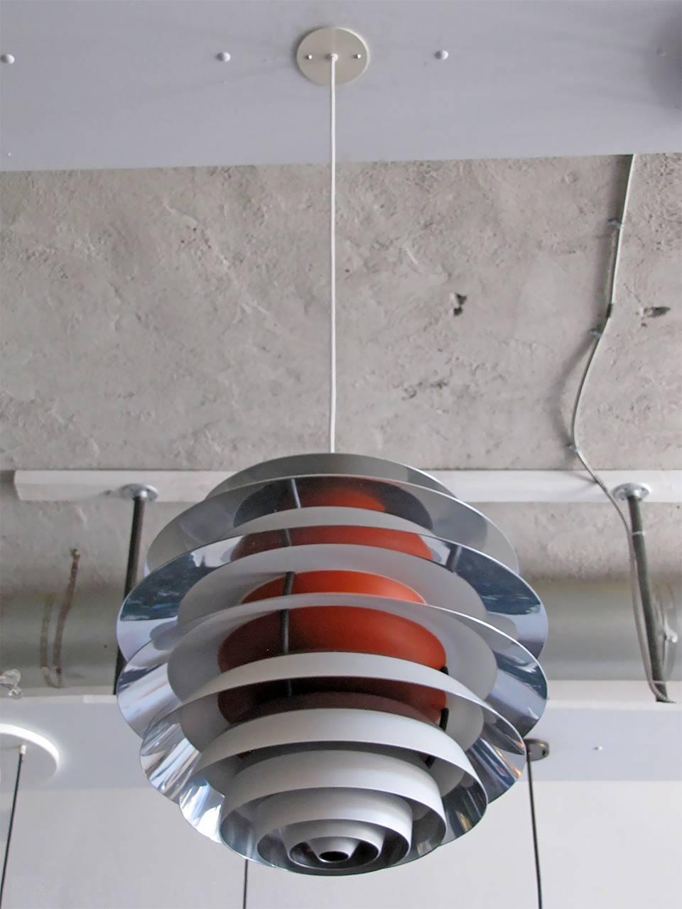 Stunning Poul Henningsen "Kontrast" lamp in excellent original condition.
Pendant is composed of ten concentric, stacked rings in orange, off-white
and polished aluminum that produce a wonderful, glare-free light.