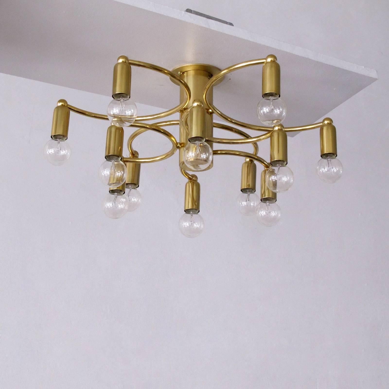 Wonderful brass twelve-light flush mount ceiling light with two tiers of three semi-circular arms, each equipped with two sockets on either end, can be used as wall sconce or ceiling light.