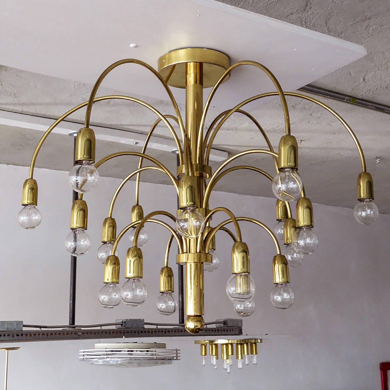 Wonderful German three stage, eighteen-arm fountain chandelier or flush mount in brass with six arms per stage.