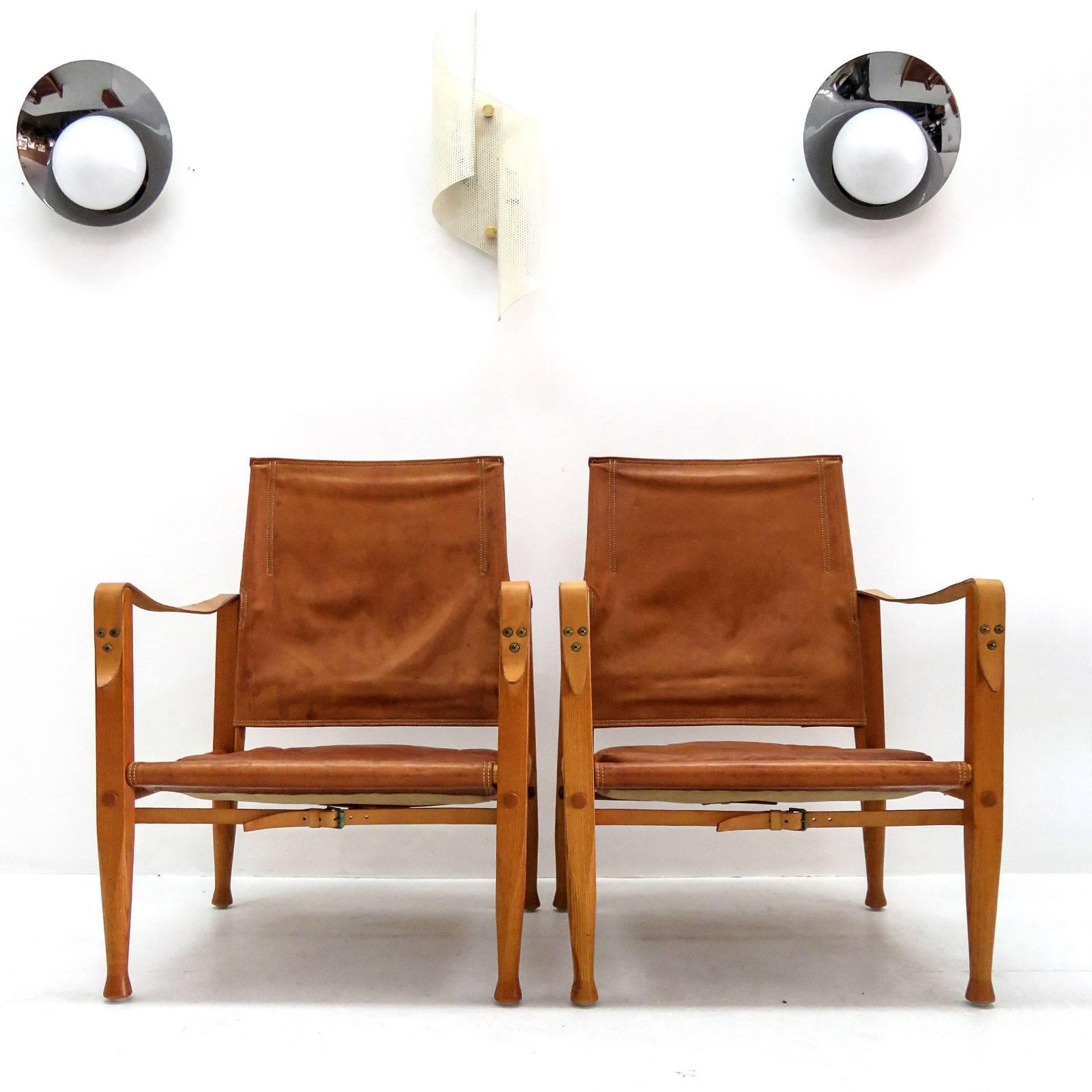 Stunning safari chair designed by Kaare Klint for Rud. Rasmussen's Snedkerier with patinated ash frame, seat, back, straps and loose cushions in patinated leather, designed in 1933, produced 1969, natural patina. One available.