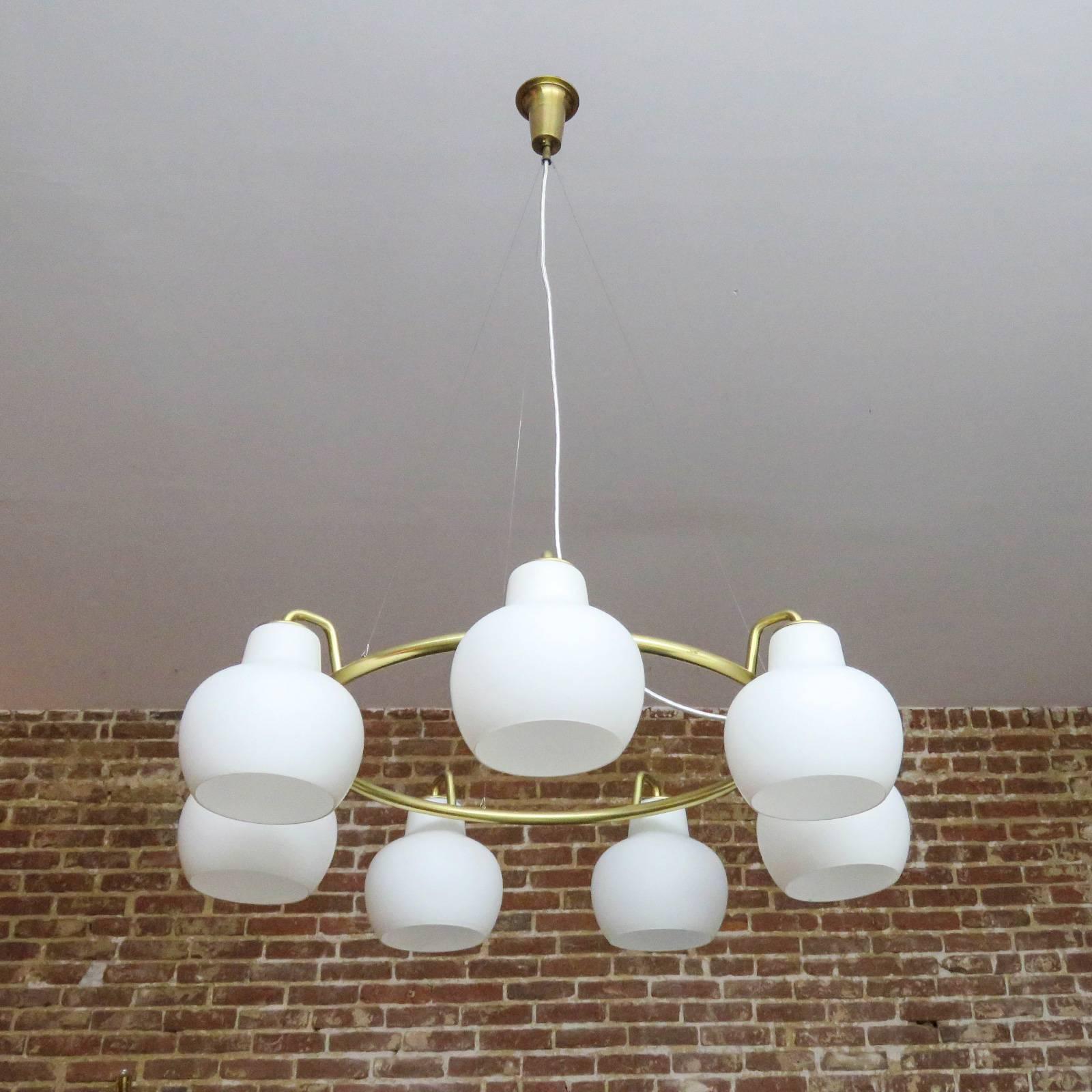 Stunning, large-scale Christiansborg / B&G ring chandelier by Vilhelm
Lauritzen, with seven white opaline glass shades on a circular brass frame
suspended from cables, height is adjustable.