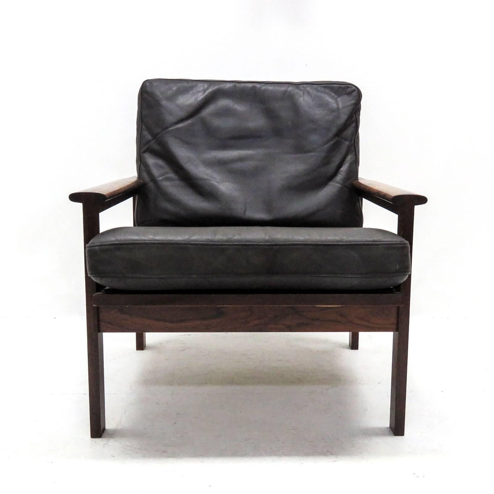 Remarkable pair of easy chairs from the Capella series, designed by Illum Wikkelsø, produced by Niels Eilersen in Denmark, designed in 1959, solid palisander frames with loose cushions in original black leather with minor normal traces of wear.