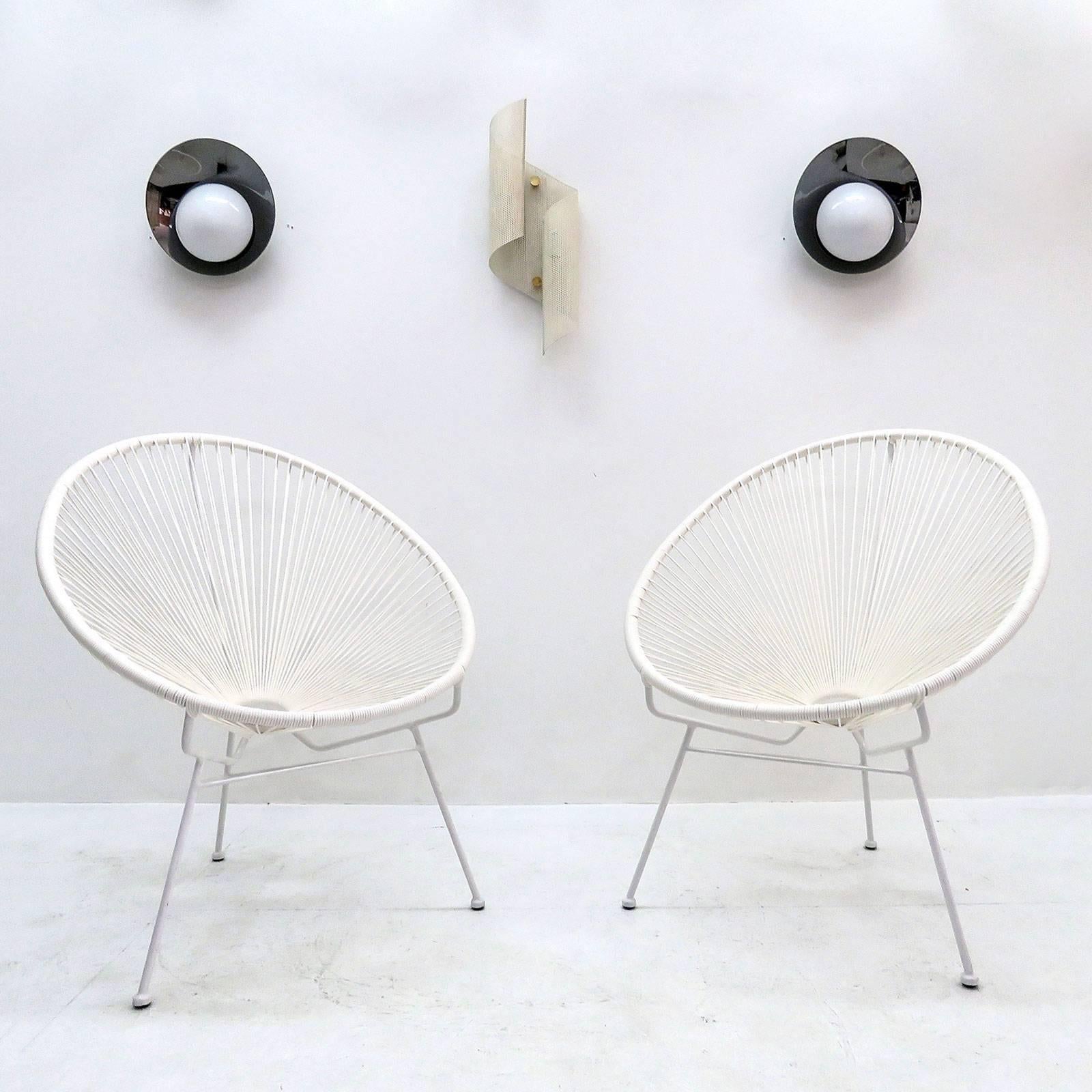 Wonderful pair of white tripod hoop chairs in style of the iconic 1960s Acapulco chair, with white powder coated metal frame and Polyethylene webbing, can be used indoors or outdoors.