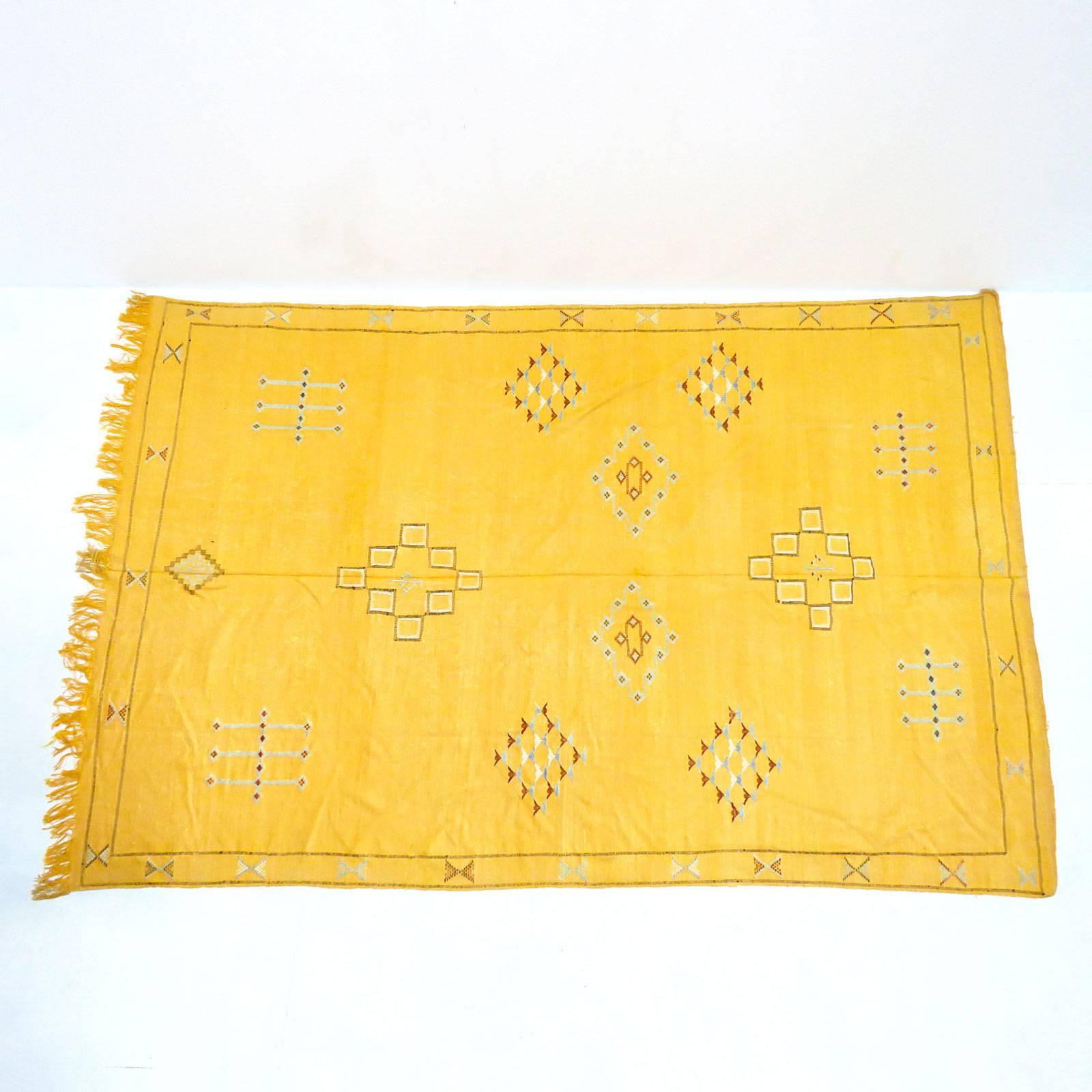 Vintage yellow or orange Moroccan Kilim with poly-chrome stylized patterns, fringes on one end.