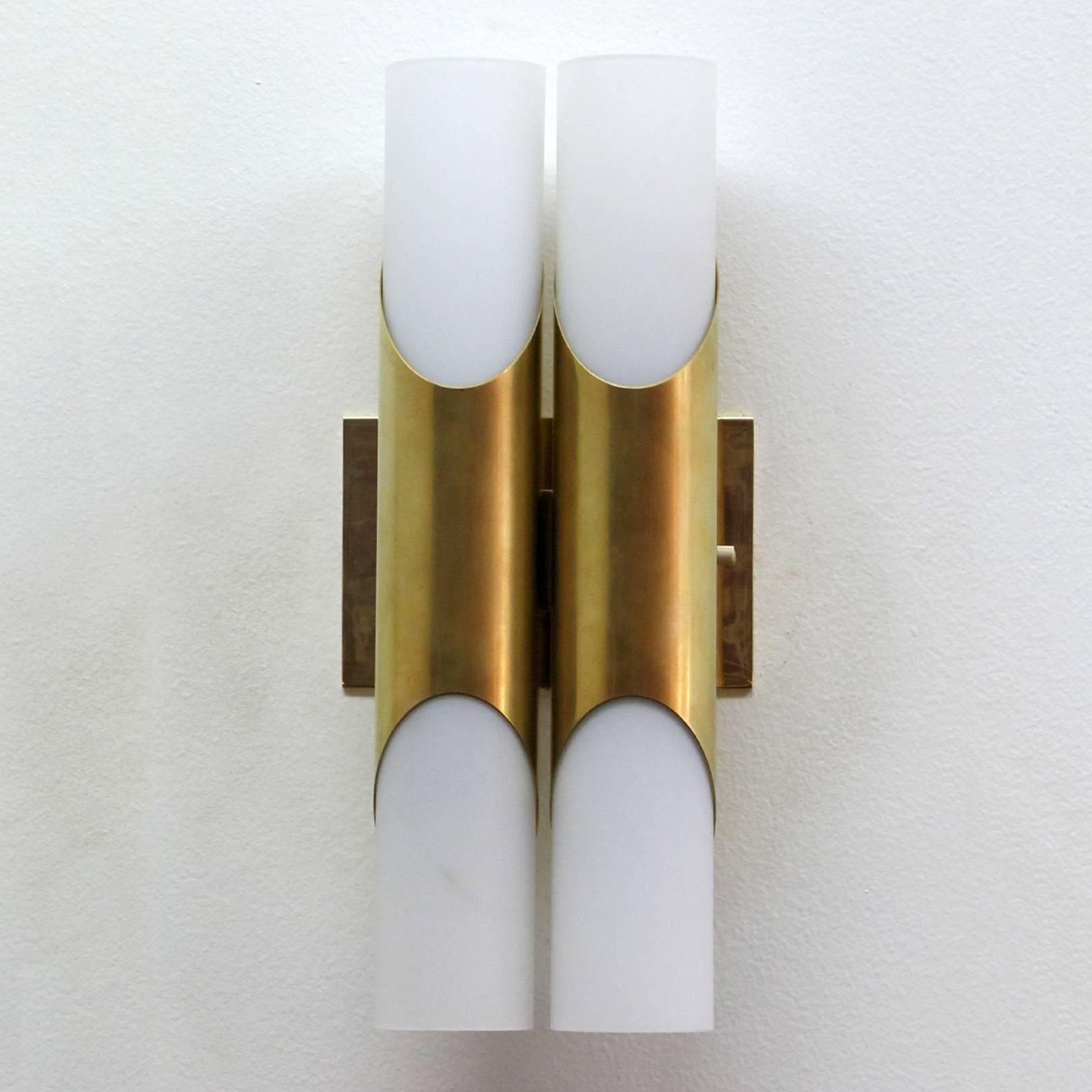 Simply elegant pair of 1970s brass double wall lights by Neuhaus Leuchten, Germany, with four-light sources each behind respective frosted glass tubes.