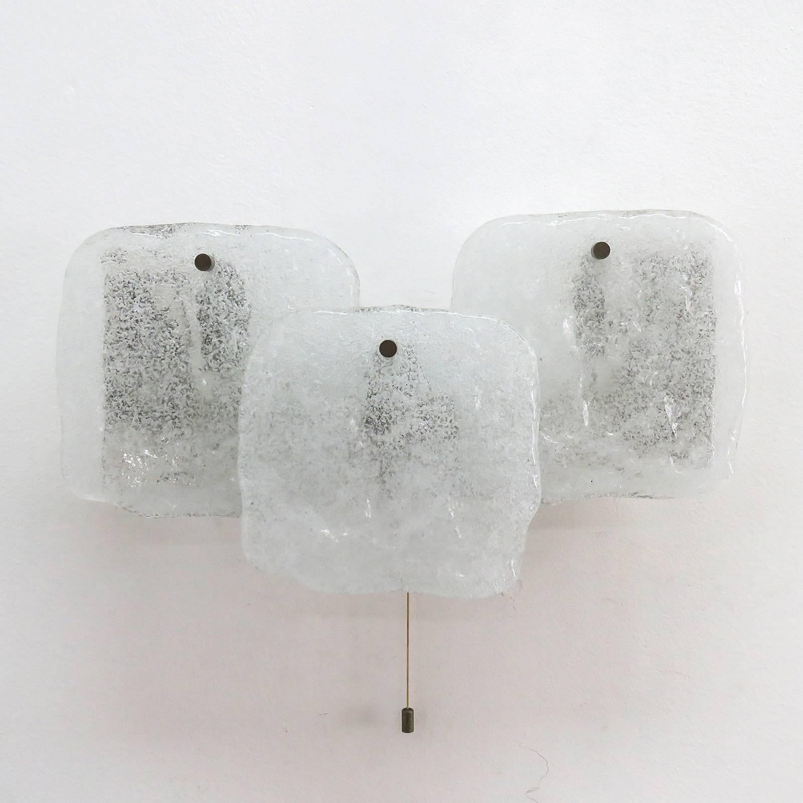 Wonderful ice glass wall lights by Kalmar Franken, Austria in the 1960s and panels with three square ice glass pieces (7 inch x 7 inch) with marginal patina on the nickel-plated metal bases, three sockets and an individual on/off pull string switch
