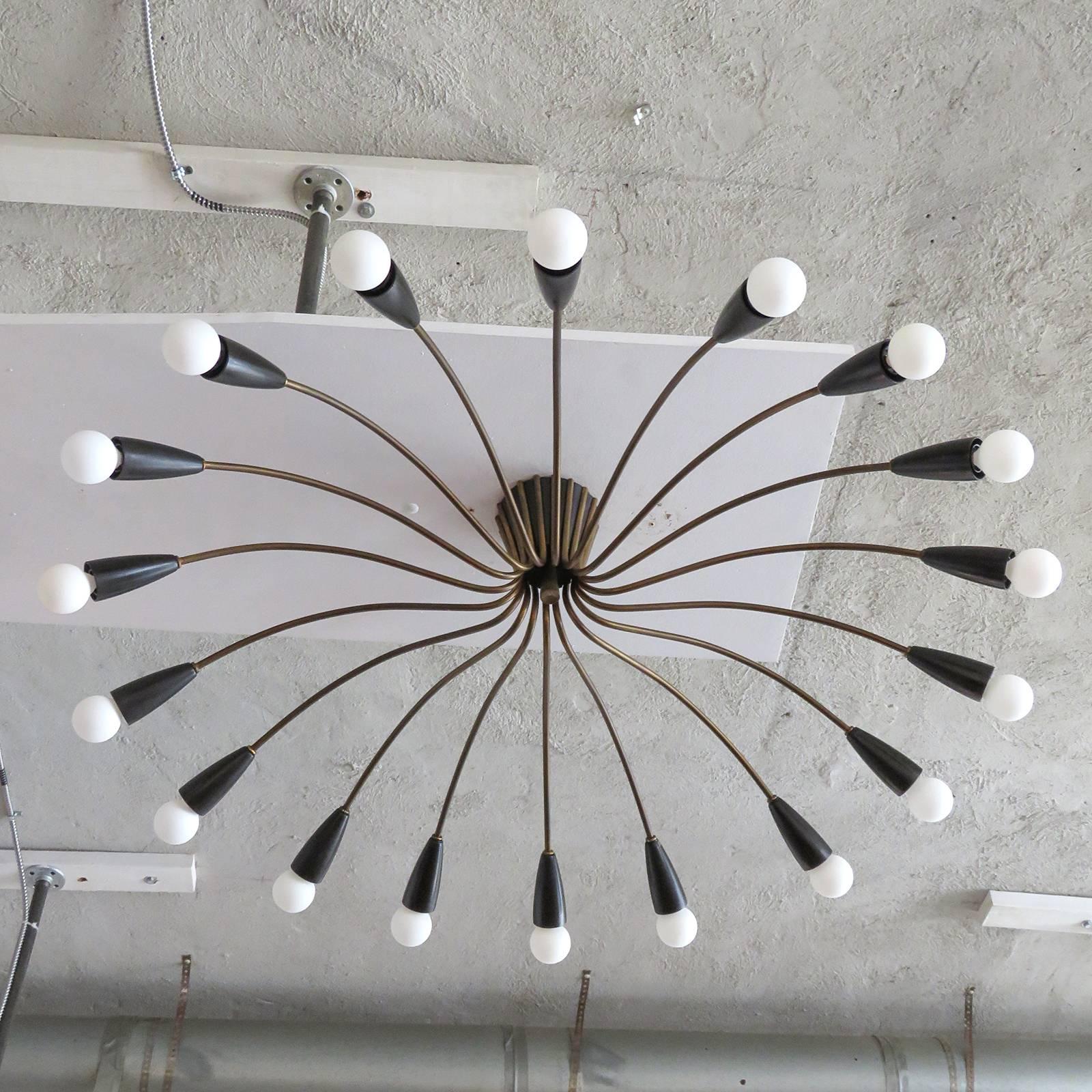 Large-scale Italian eighteen-arm flush mount chandelier, with sculptural brass arms and bakelite socket cups, can be fitted with a drop, per request.