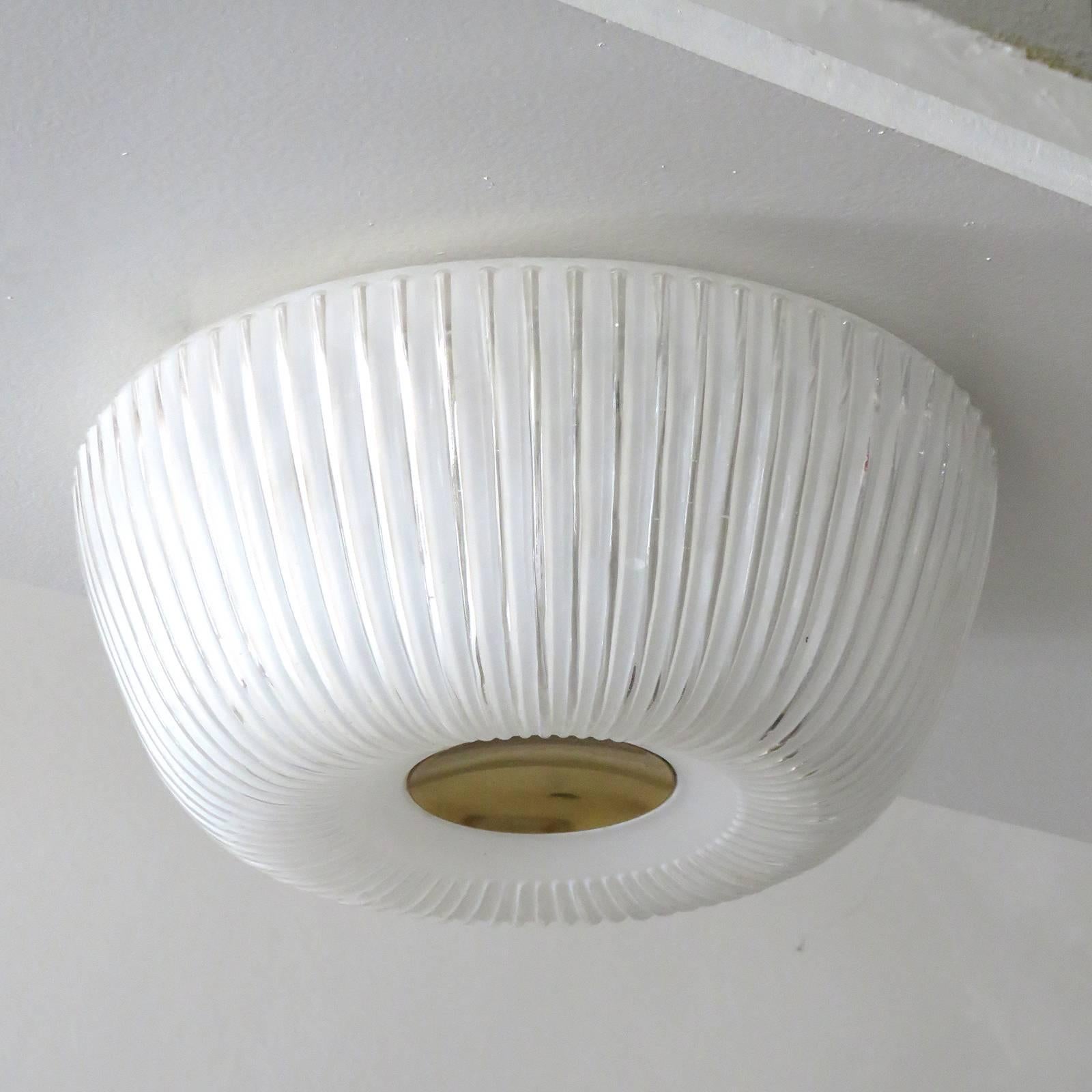 Elegant, textured glass ceiling flush mount by Doria Leuchten Germany with a circular brass center and organically shaped Minimalist glass body, marked.