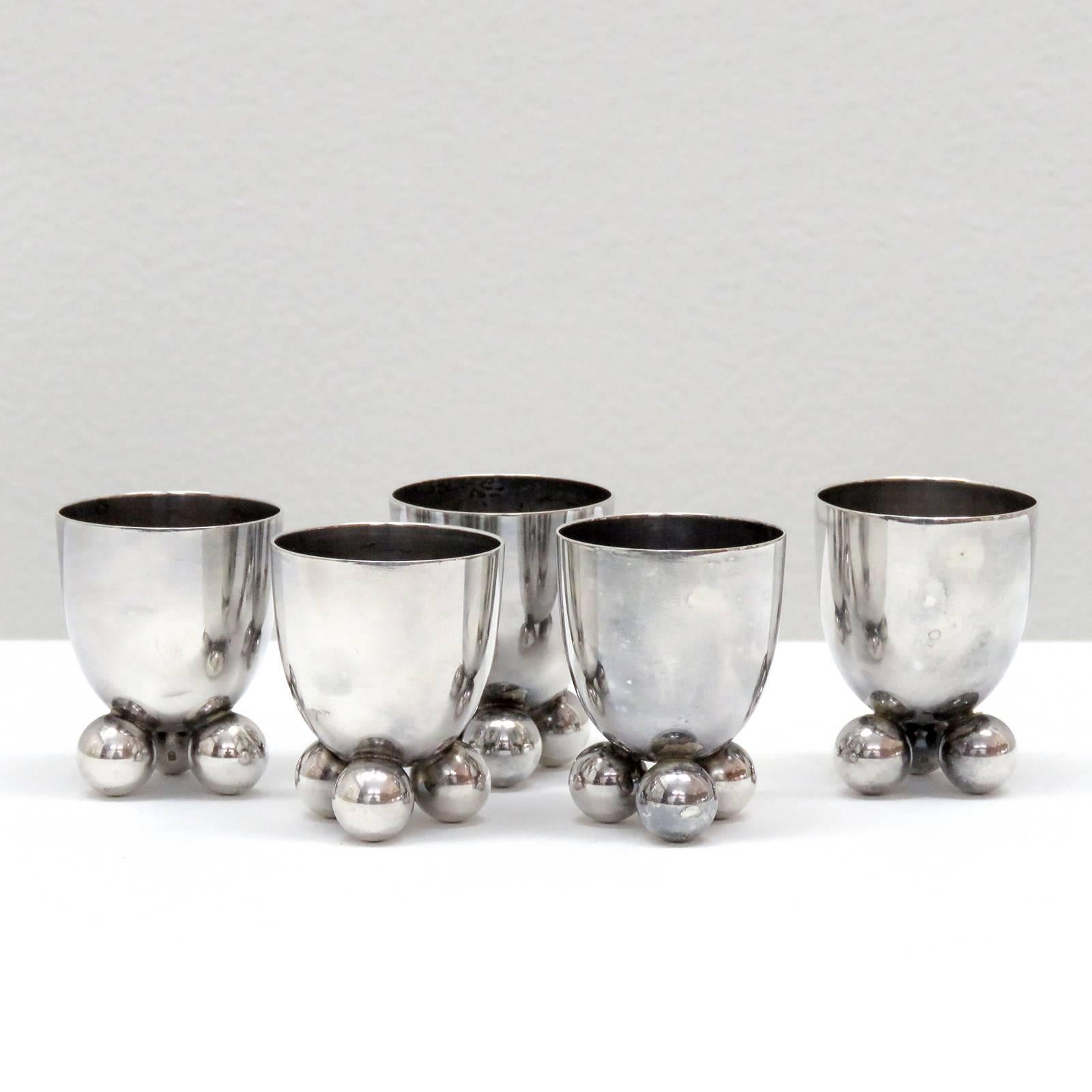 Wonderful set of five silver egg holders No.8154, by F. A. Breuhaus De Groot for WMF, each cup sits on three small solid spheres.