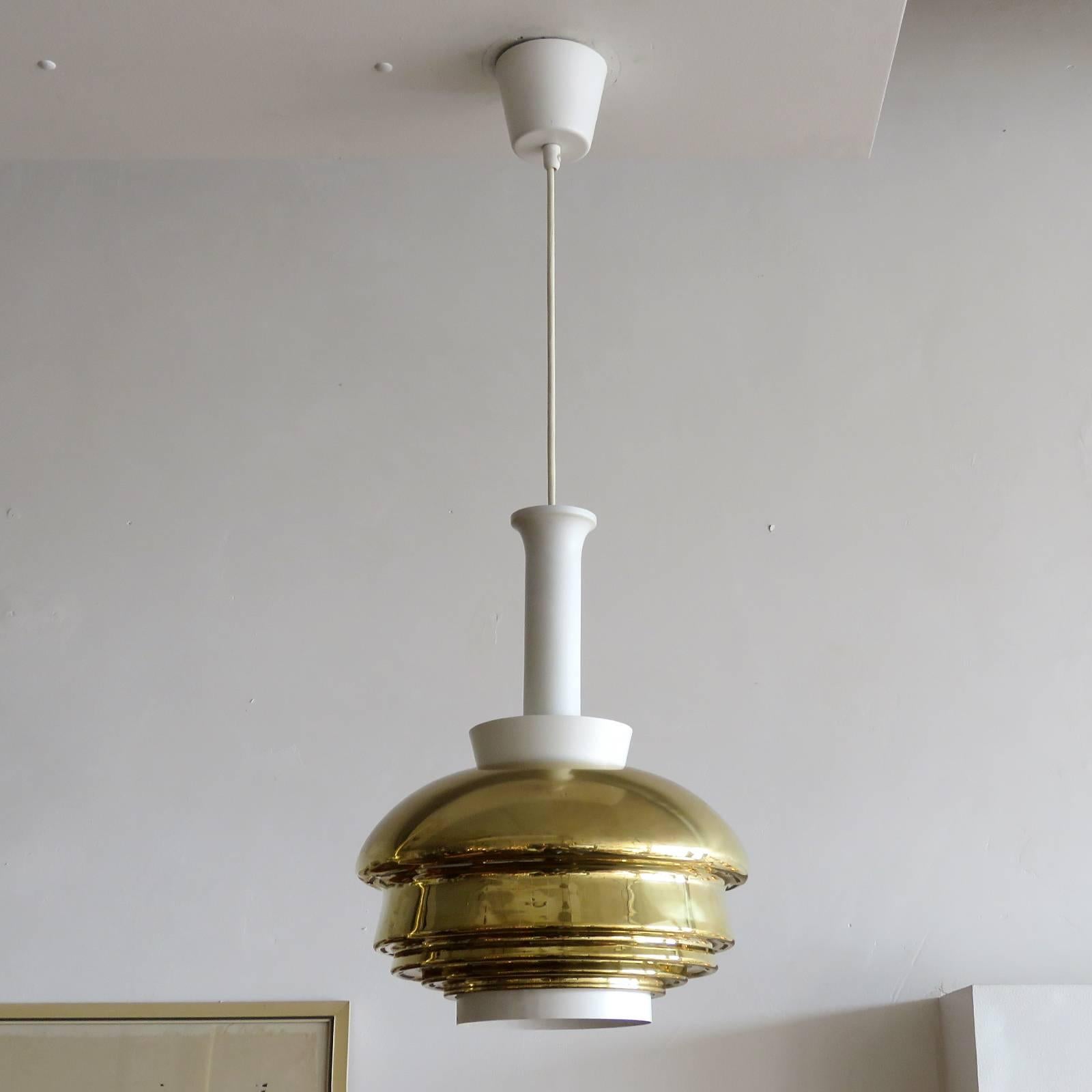 Wonderful pendant light, model A335 by Alvar Aalto, in brass and white enameled metal, with original metal canopy and white bottom rim, early example by original manufacture Valaistustyö, Finland, 1952, stamped with manufacture's mark.