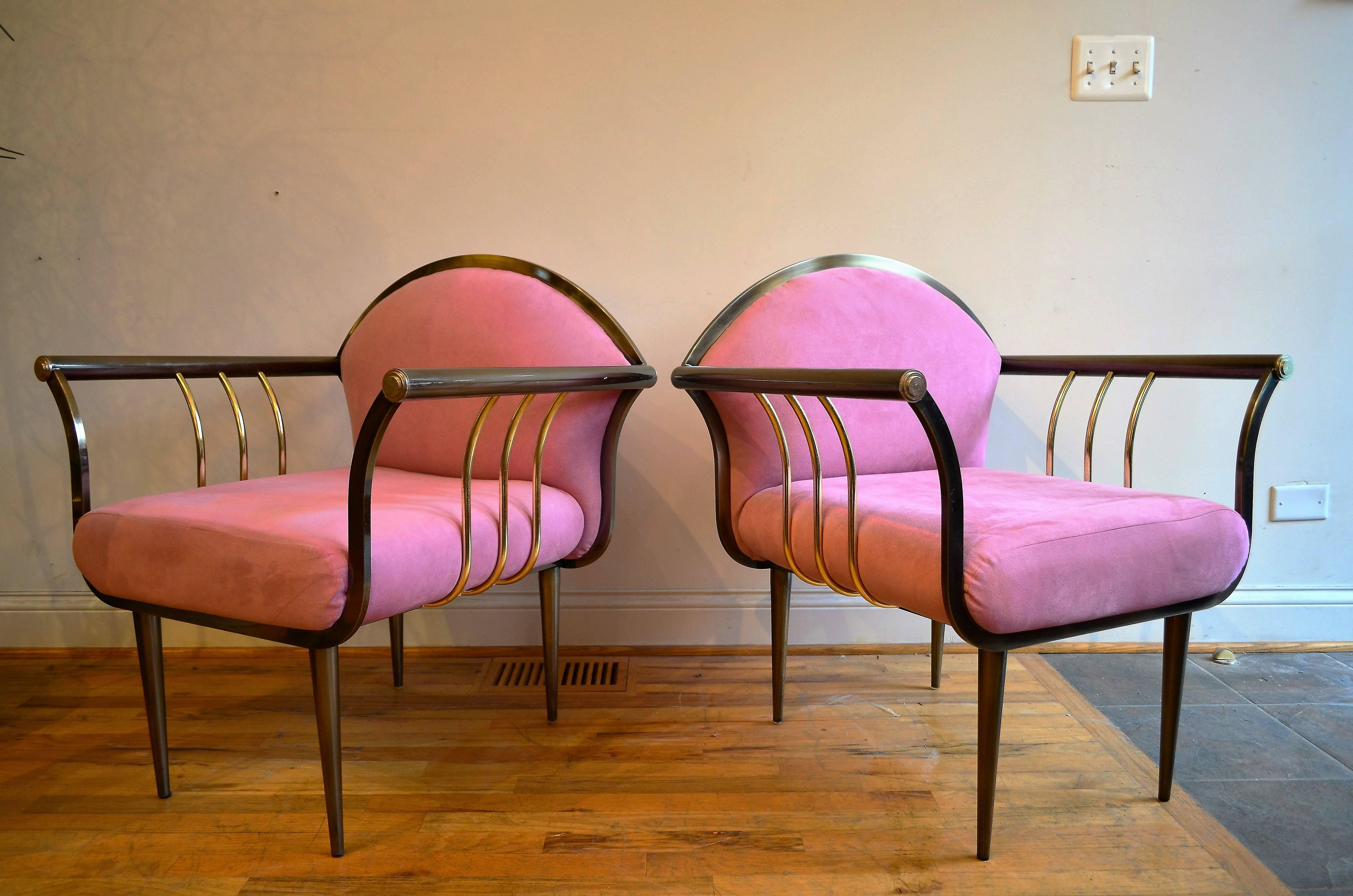A pair of DIA Memphis style bronze and brass armchairs.
The chairs are upholstered in pink ultrasuede. 
