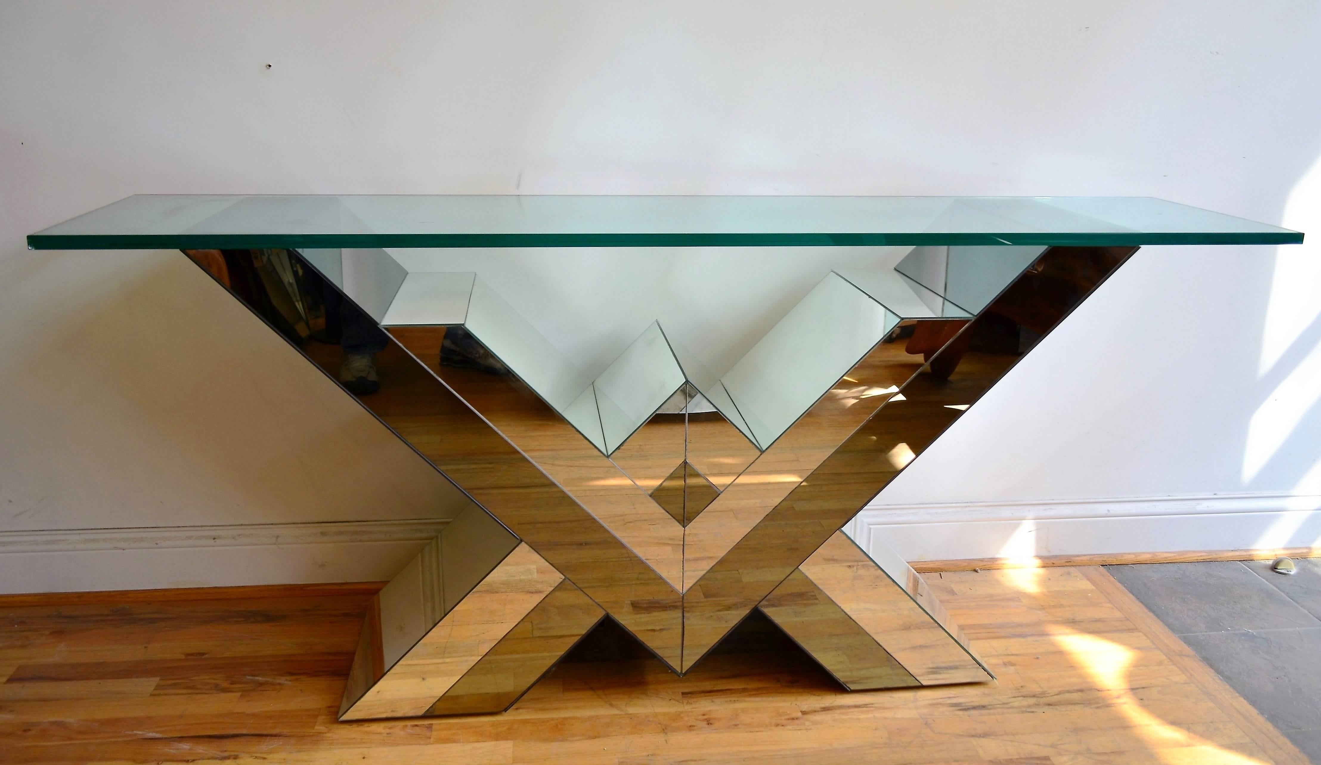 A striking 1970s Mid-Century console table clad in smoked and clear mirrors on all four sides. The top glass is thick and substantial. In style of Pierre Cardin.