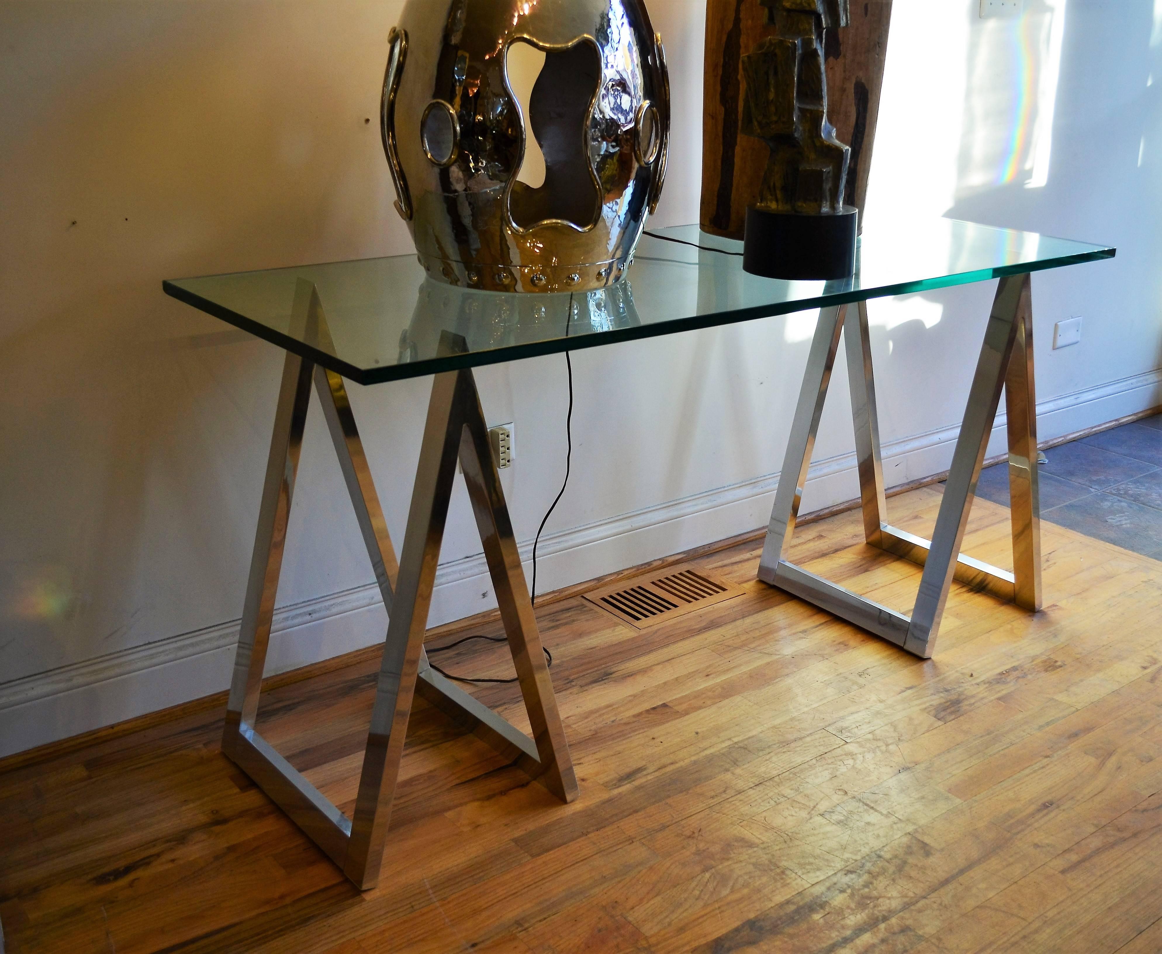 Chrome sawhorse leg console table or desk. The finest quality construction chrome and glass saw horse table by Metal Dimensions.
Fantastic original thick glass top. Great computer work table.