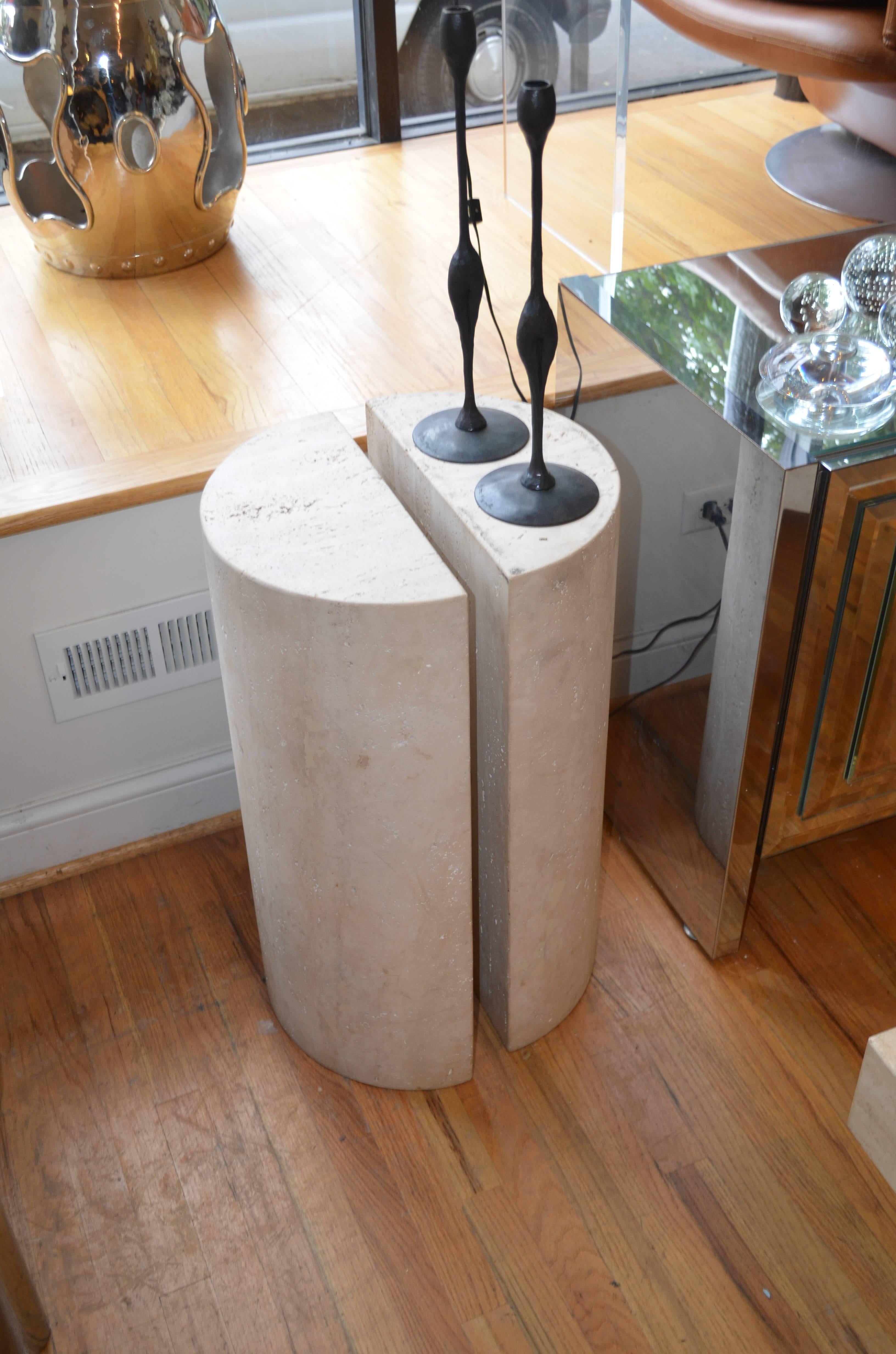 A beautifully honed hand carved Belgium Travertine pedestal.
It is crafted from a solid slab of Travertine. The pair of
semi circular bases are quite versatile.
The holes in the surface were never filled and makes it much more interesting than