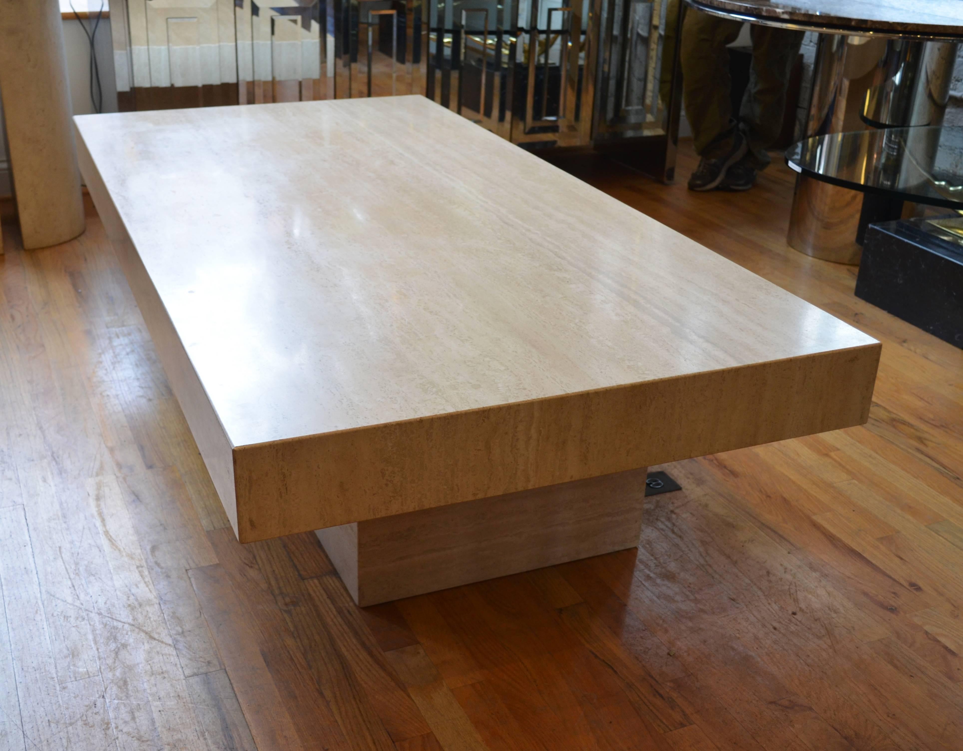 A monumental Italian richly veined Travertine 
pedestal coffee table. This custom made coffee 
table features a 5 inch wide Travertine overhang on its four sides.
This well crafted table has a comanding presence.