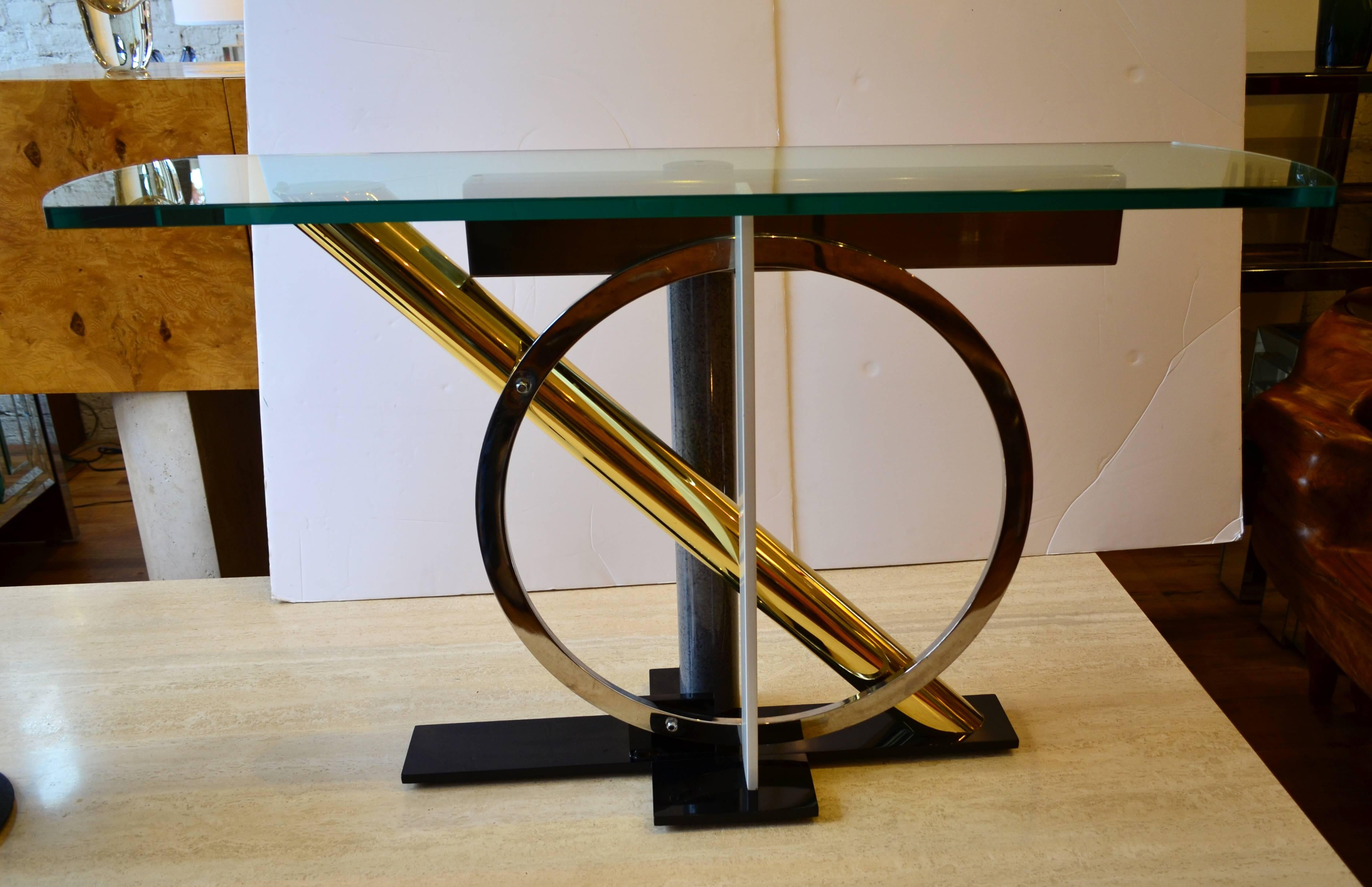 A Design Institute of America console table by
Kaizo Oto. This Memphis style geometric console
is a mixed-metal composition of brass, chrome and
enameled steel. Furniture as art. Excellent original condition.
The glass is very thick.