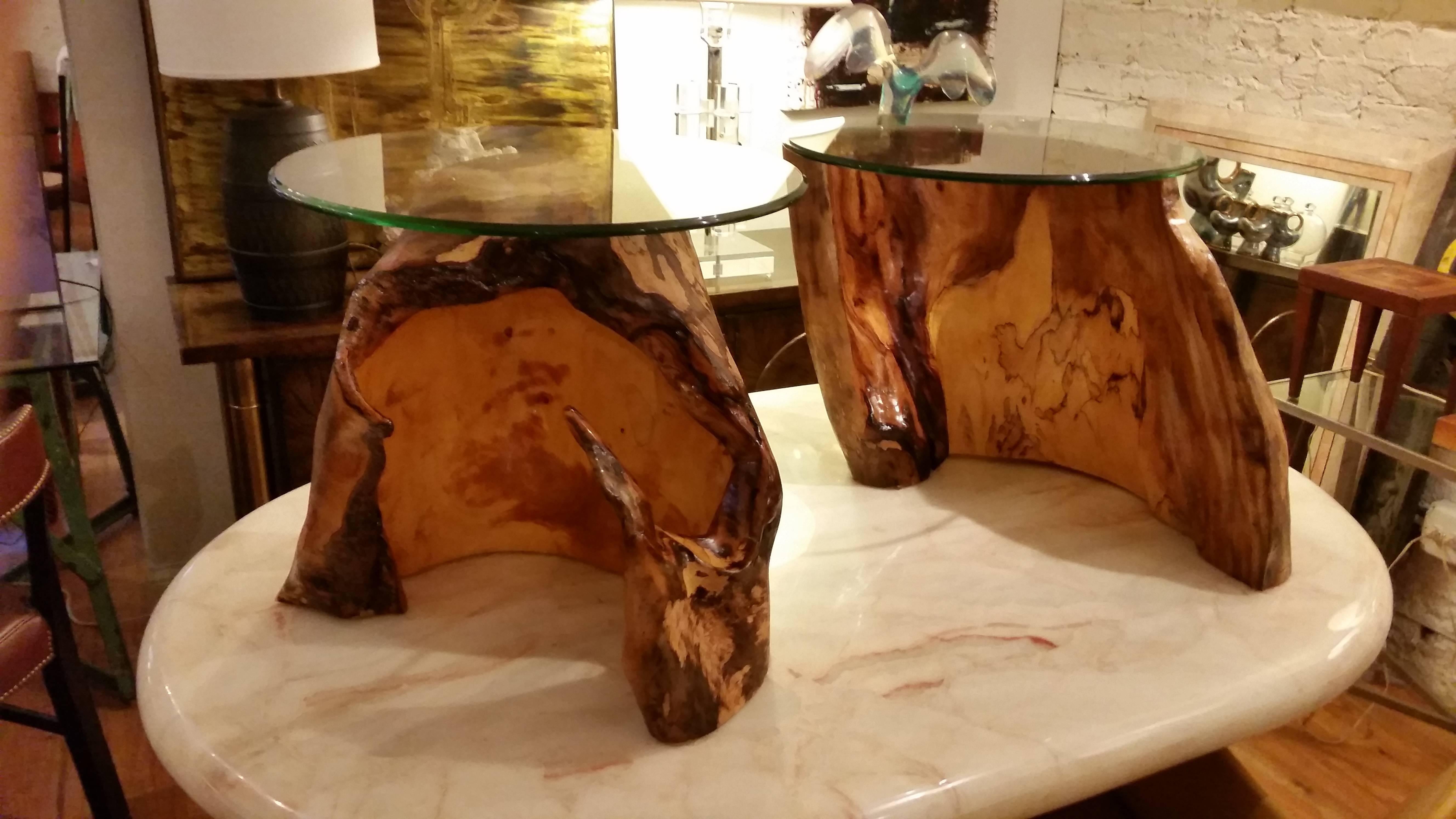 A pair of natural organic end tables topped with 20 inch.
Glass tops. Bold organic forms. Could work well as a coffee table.