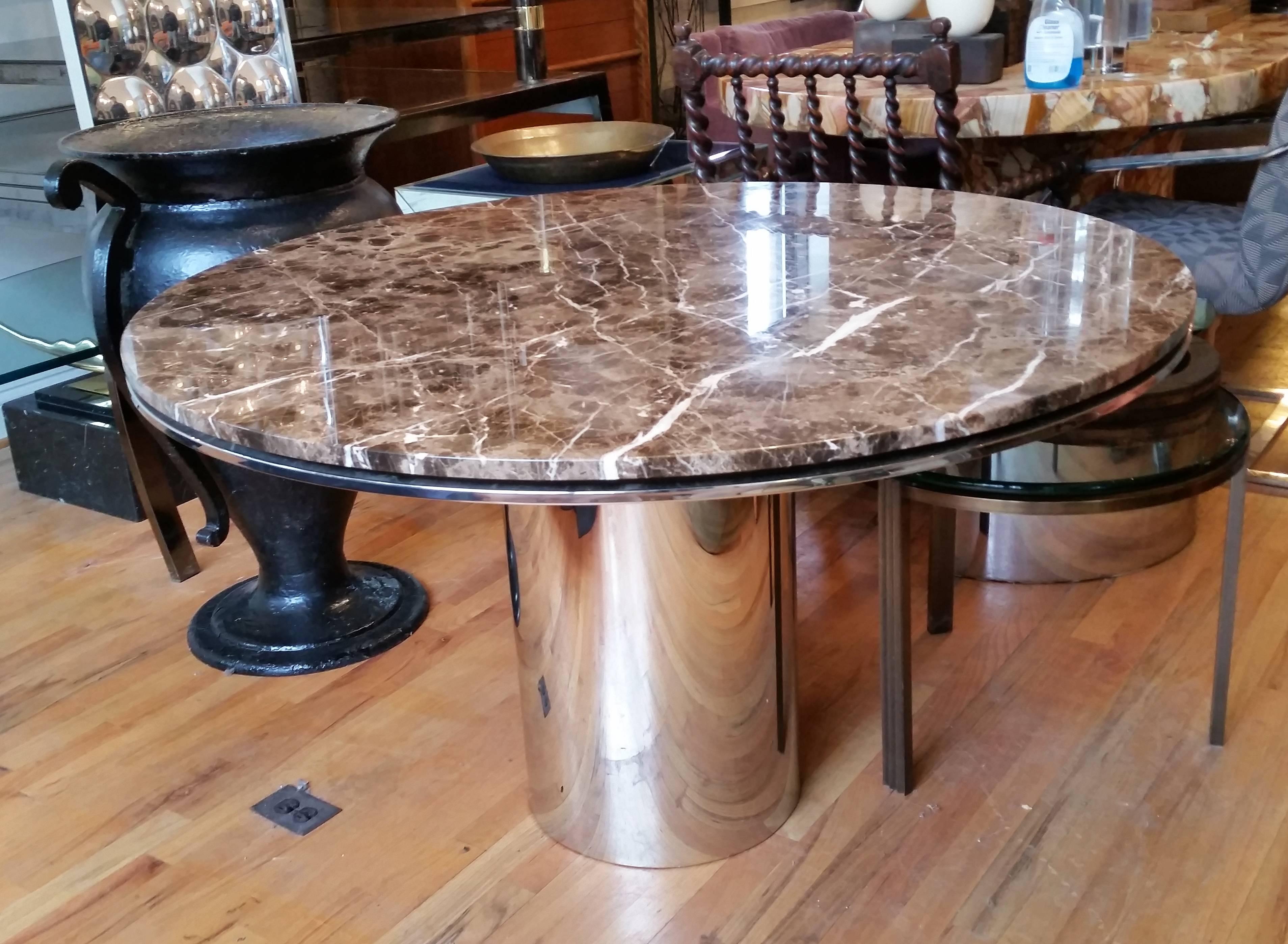 Brueton's Anello table in marble and chrome. 
The marble floats on a stainless steel top. The base is a seamless chromed stainless steel column. Outstanding quality. Excellent proportions. 
Would also make an elegant center table.