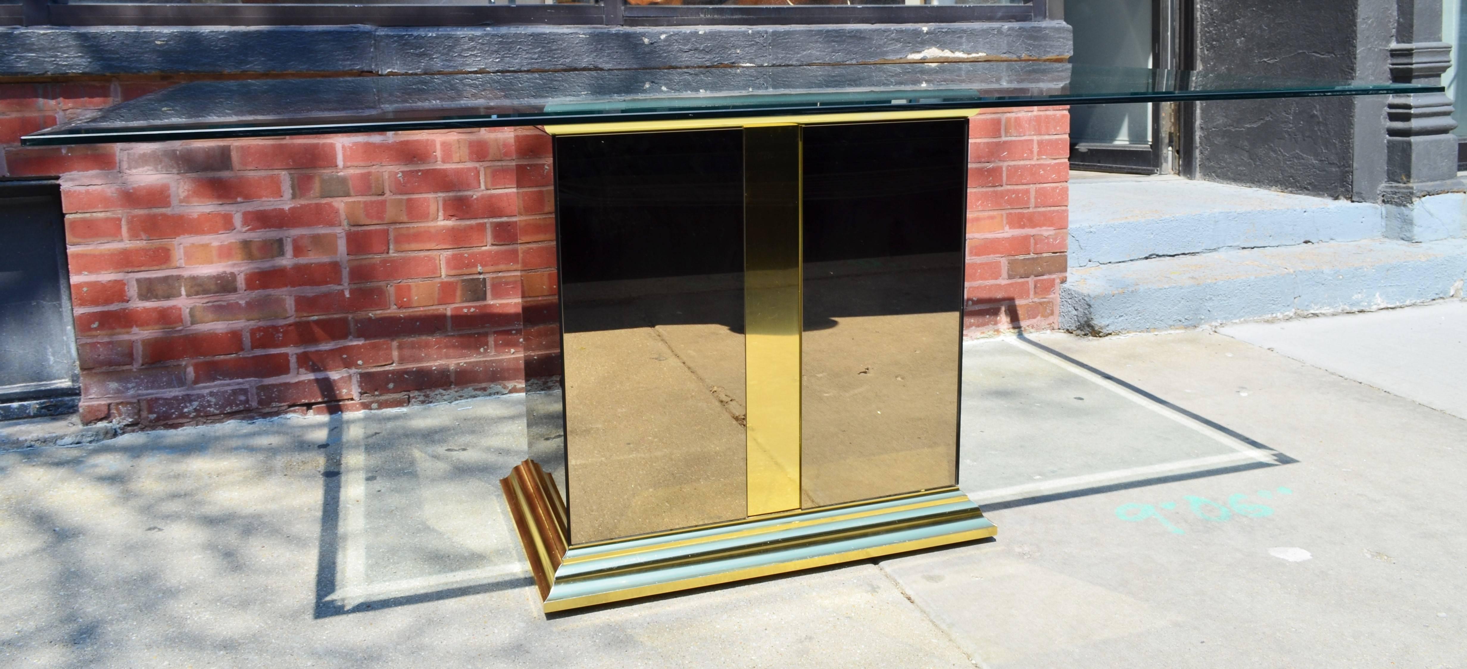 The pedestal is clad in bronze tinted mirrors and is
trimmed in brass. The table has an original beveled glass top.
     