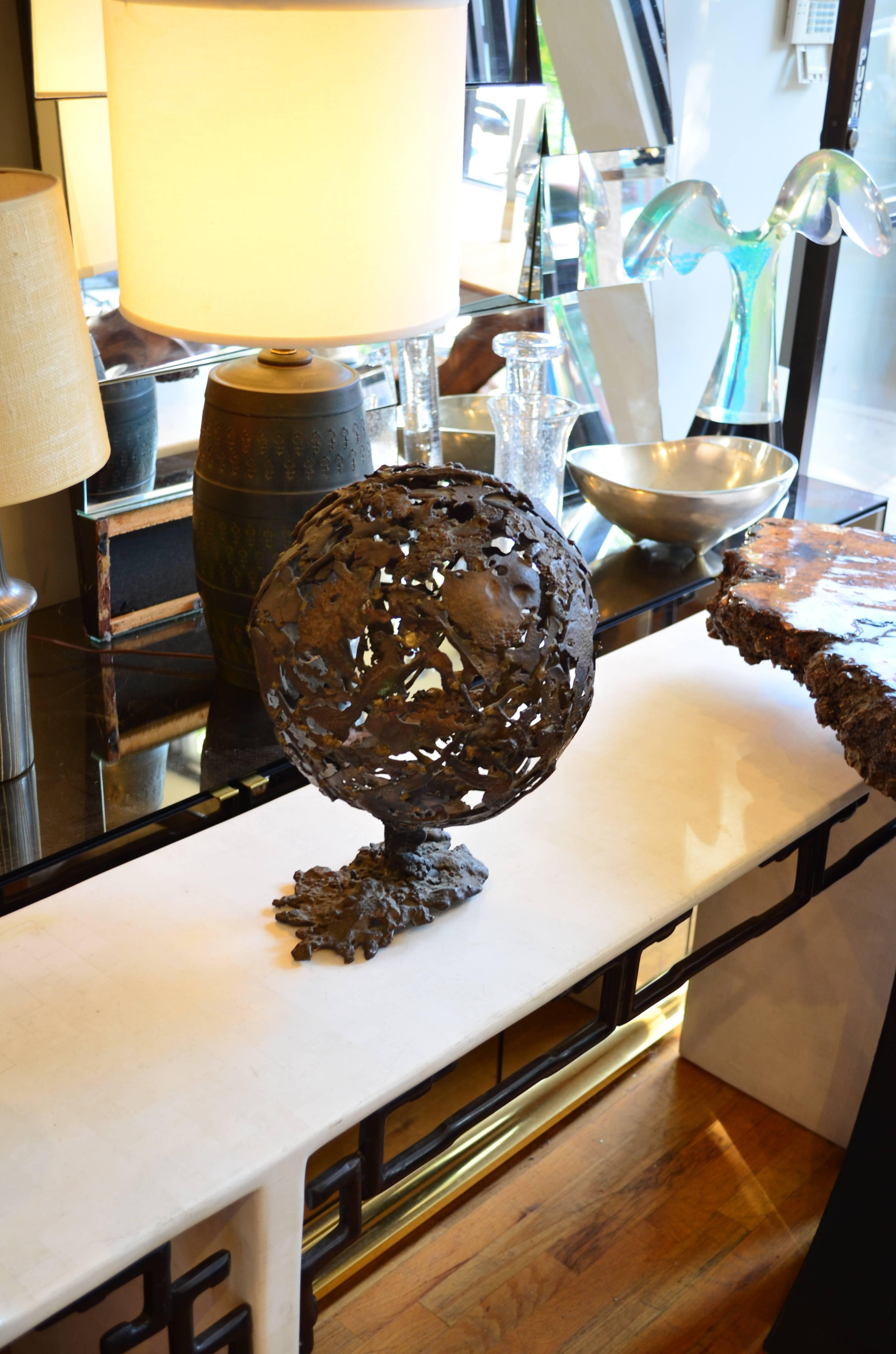 An exceptional organic Brutalist orb shaped sculpture.
This large scale piece is constructed of torch cut steel with a
heavy verdigris patina. The steel pieces are welded together into a monumental
globe. Artist is unknown and the piece appears