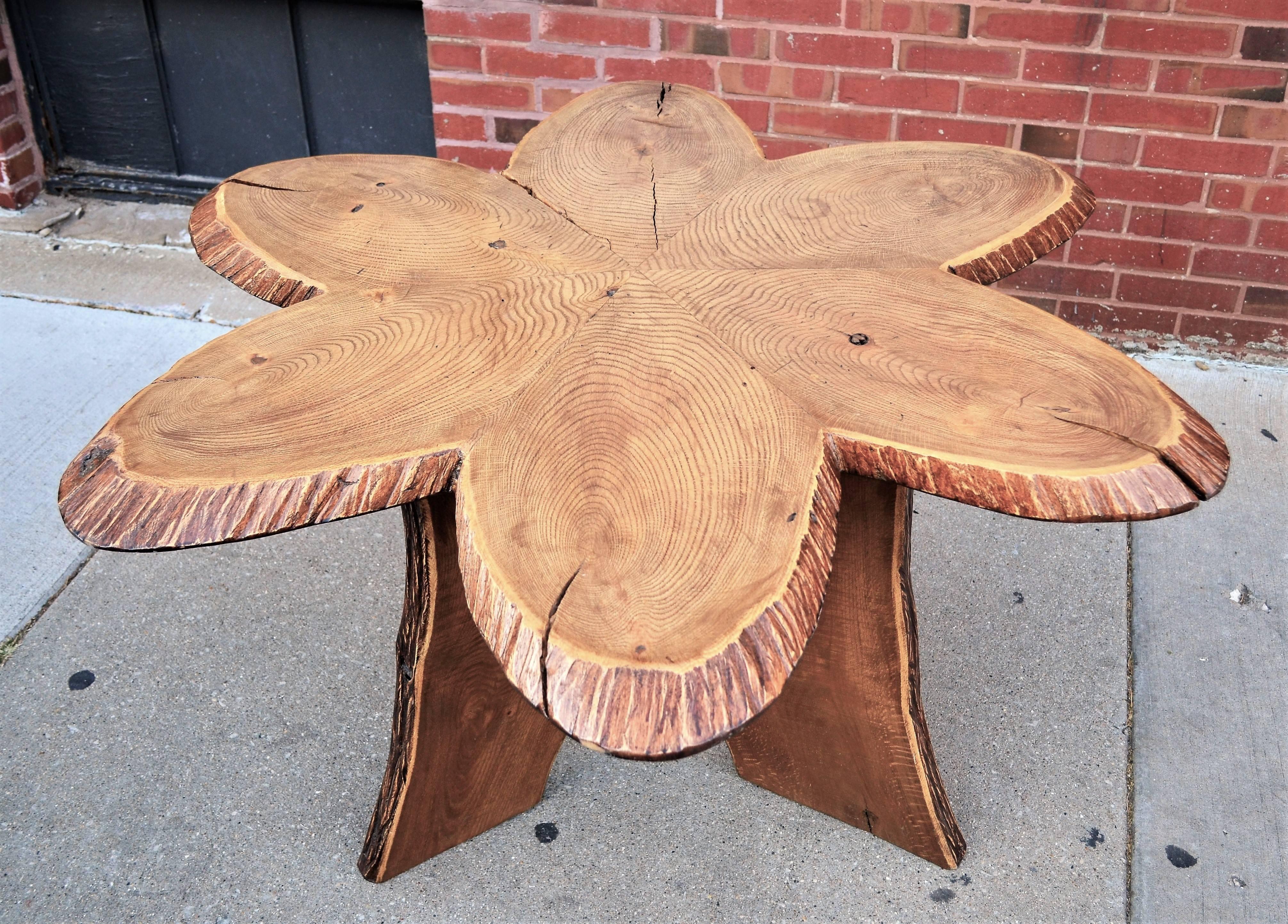 Oak Andironack table.One of a kind six petal folk art table. Undoubtedly commissioned by a master craftsman. Six oak slabs rest on a wood tripod base. There is a separation between two of the top slabs. Please see images. Given its versatile size